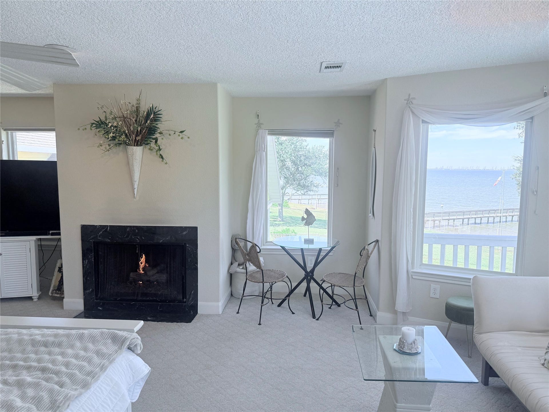4715 W Bayshore Drive, Bacliff, TX 77518 Windows all around the Primary Suite. Fireplace for those cosy nights.