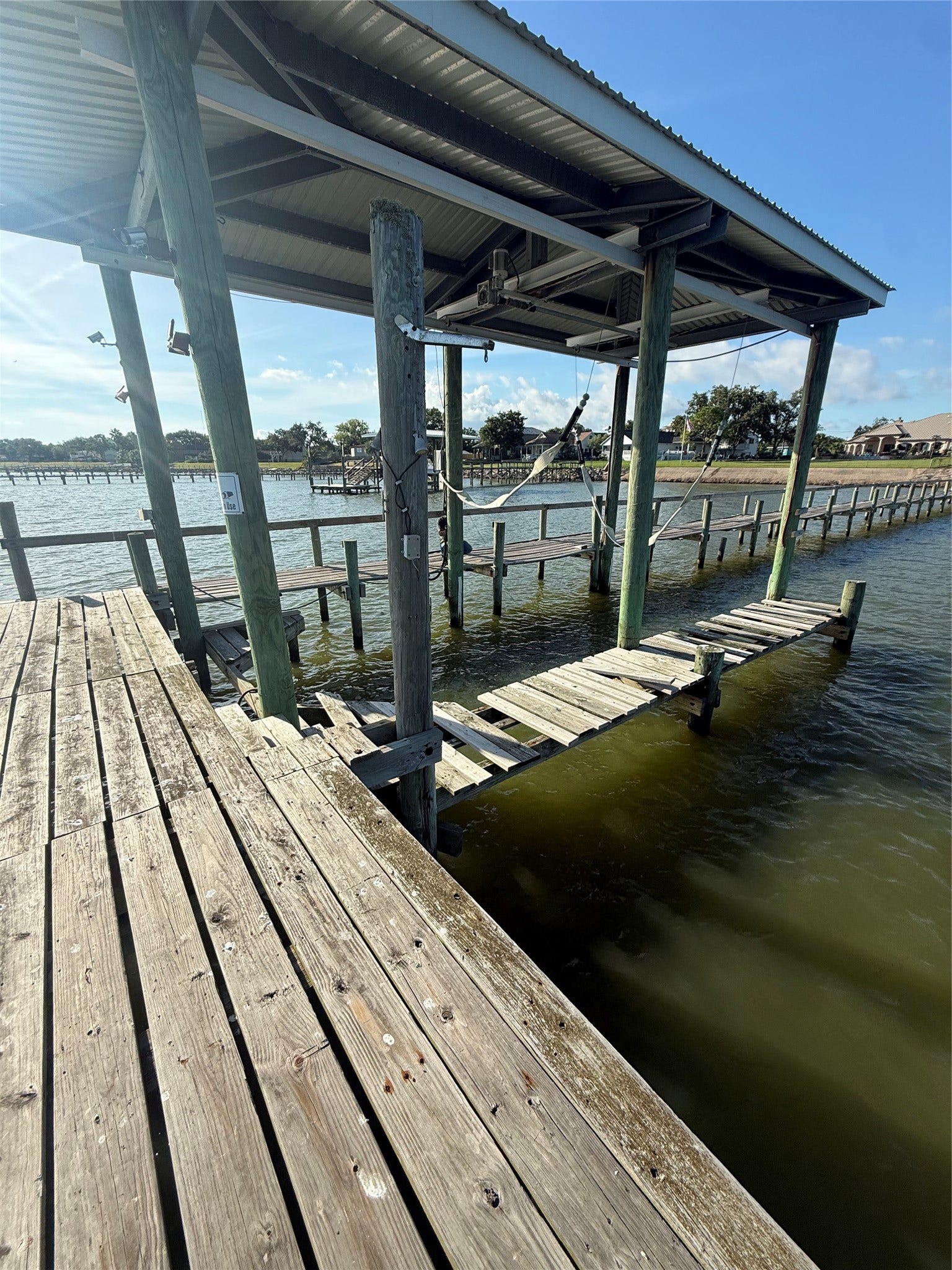 4715 W Bayshore Drive, Bacliff, TX 77518 Boat lift at the end of the pier.