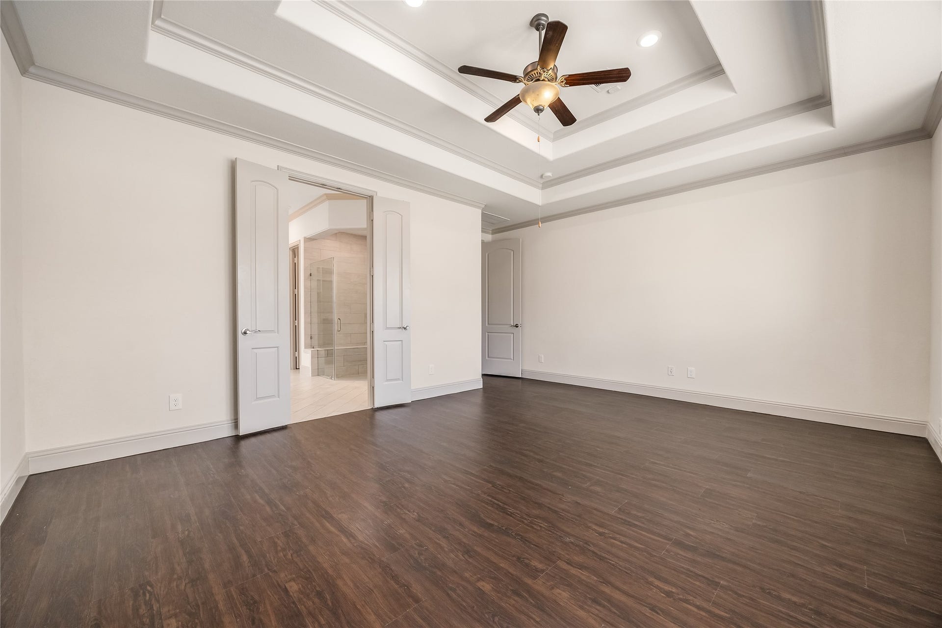 13506 COLUMBIA KEY Drive, Tomball, TX 77377 Natural light fills the primary suite, with a built-in window seat, rich wood floors, and no carpet in sight.