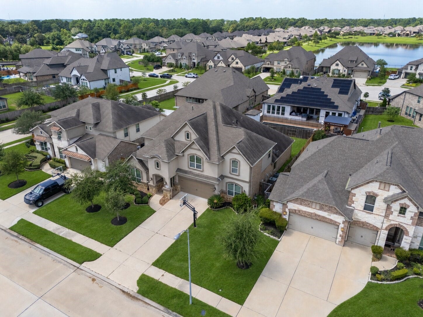 13506 COLUMBIA KEY Drive, Tomball, TX 77377 A long driveway leads to a graceful stucco faade, setting the tone for peaceful living in Tomball.