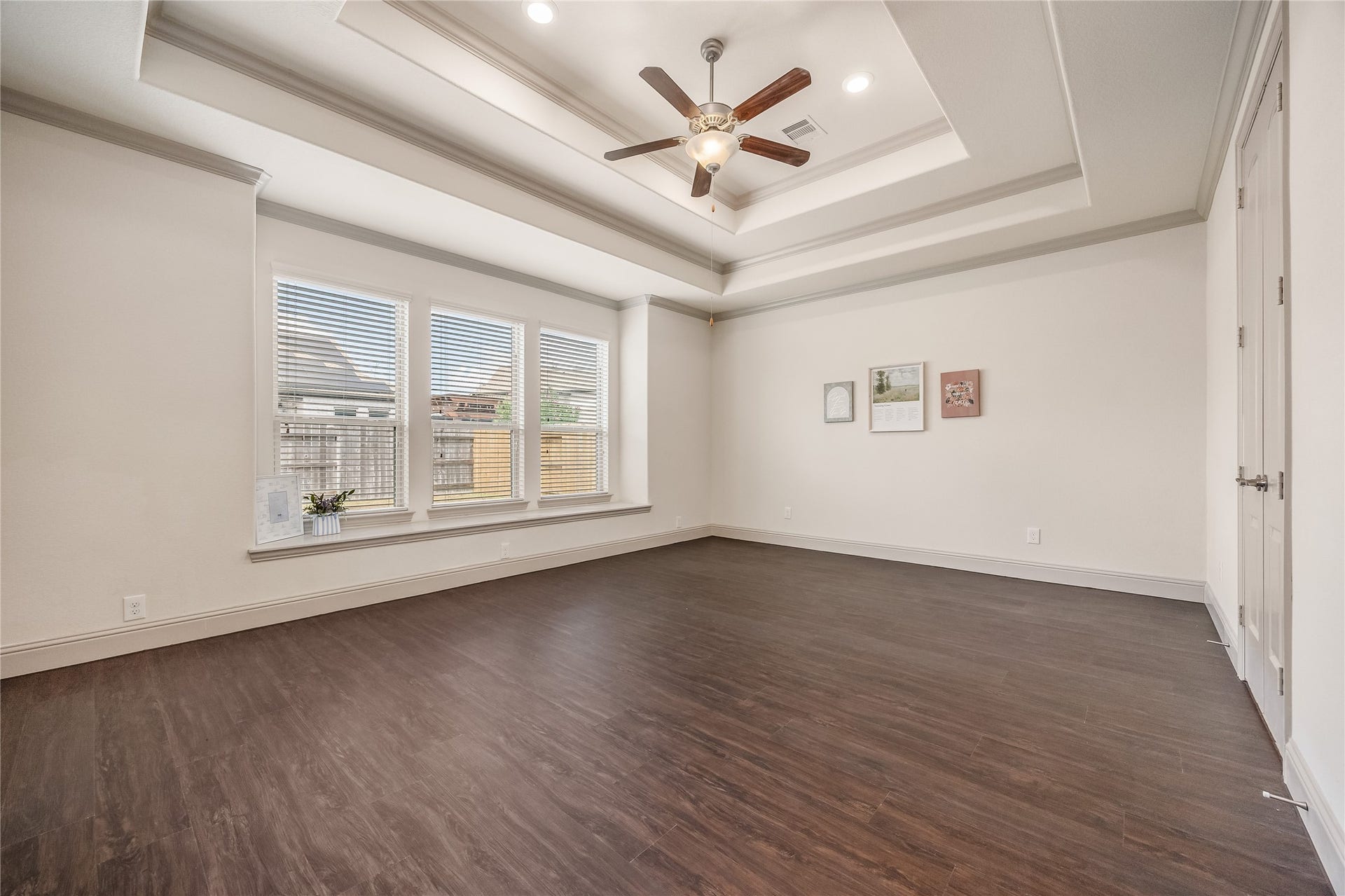 13506 COLUMBIA KEY Drive, Tomball, TX 77377 Your primary retreat pairs a layered tray ceiling with French doors to the ensuite and a cozy bench seat for quiet moments.