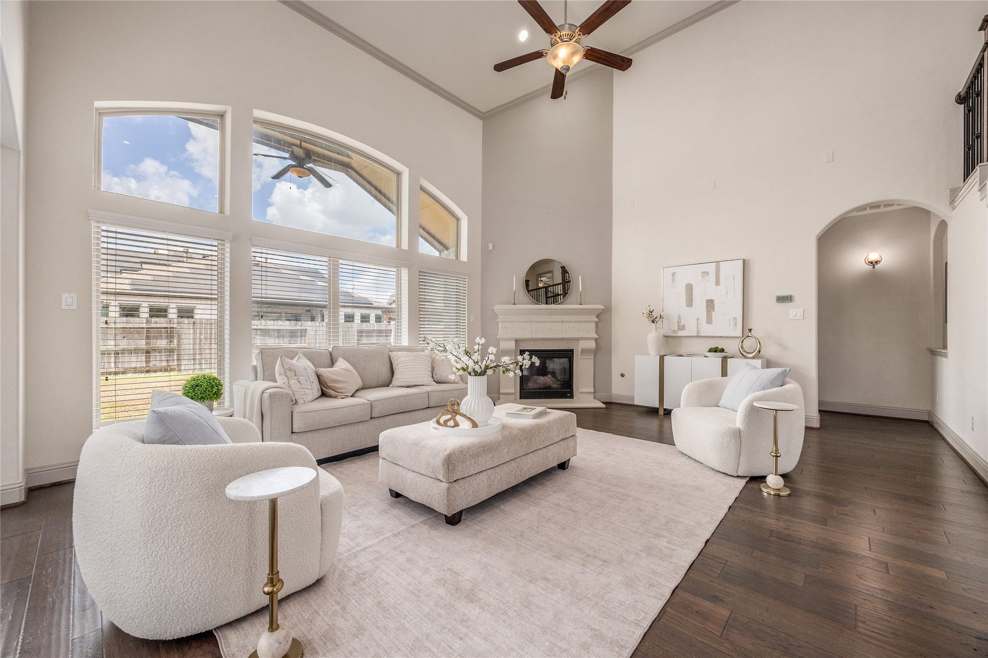 13506 COLUMBIA KEY Drive, Tomball, TX 77377 Soaring ceilings and a wall of windows fill the living room with light, while the fireplace gives it a warm focal point.