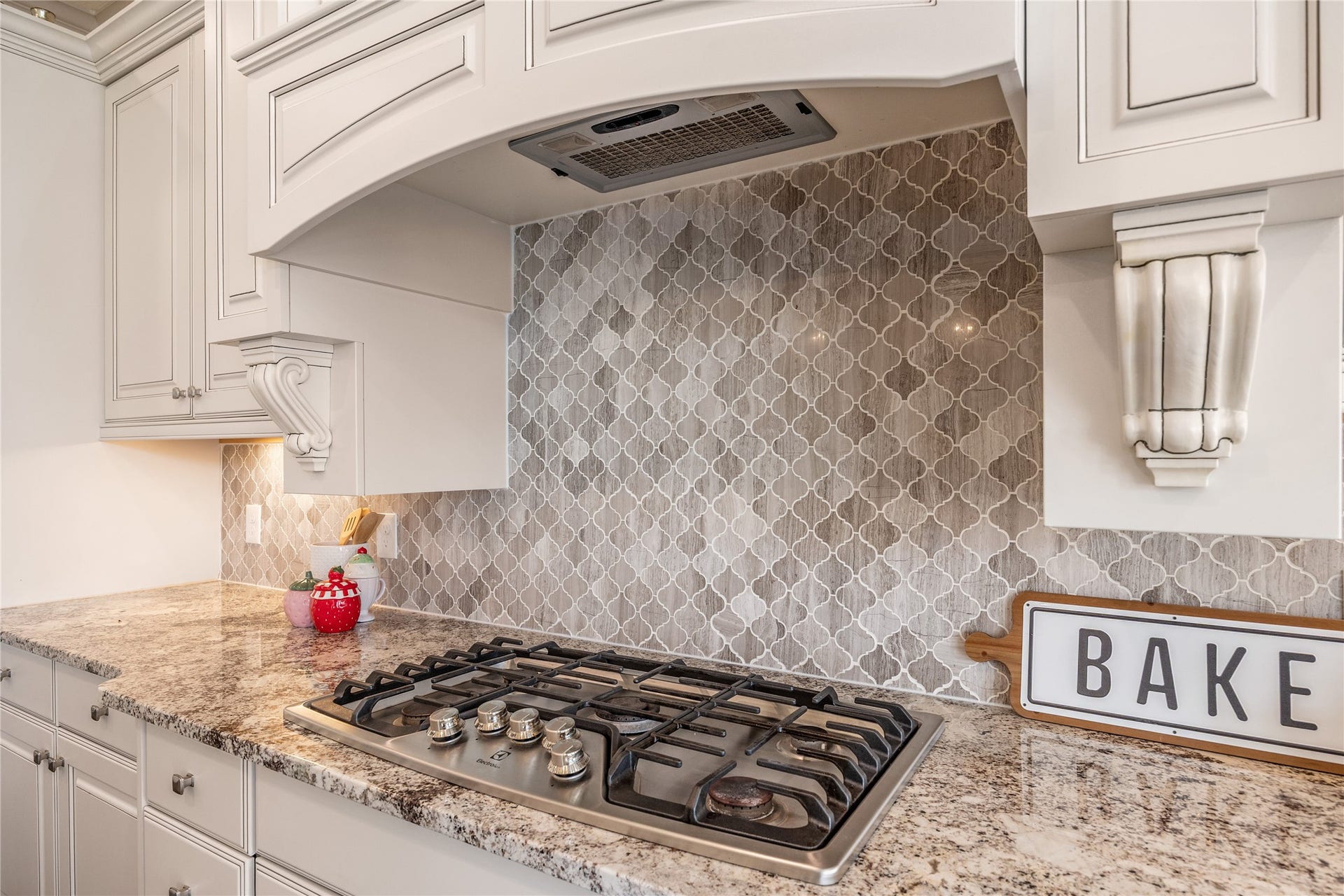 13506 COLUMBIA KEY Drive, Tomball, TX 77377 The details make this kitchen shine: an intricate tile backsplash, graceful cabinet accents, and a gas cooktop ready for your favorite recipes.