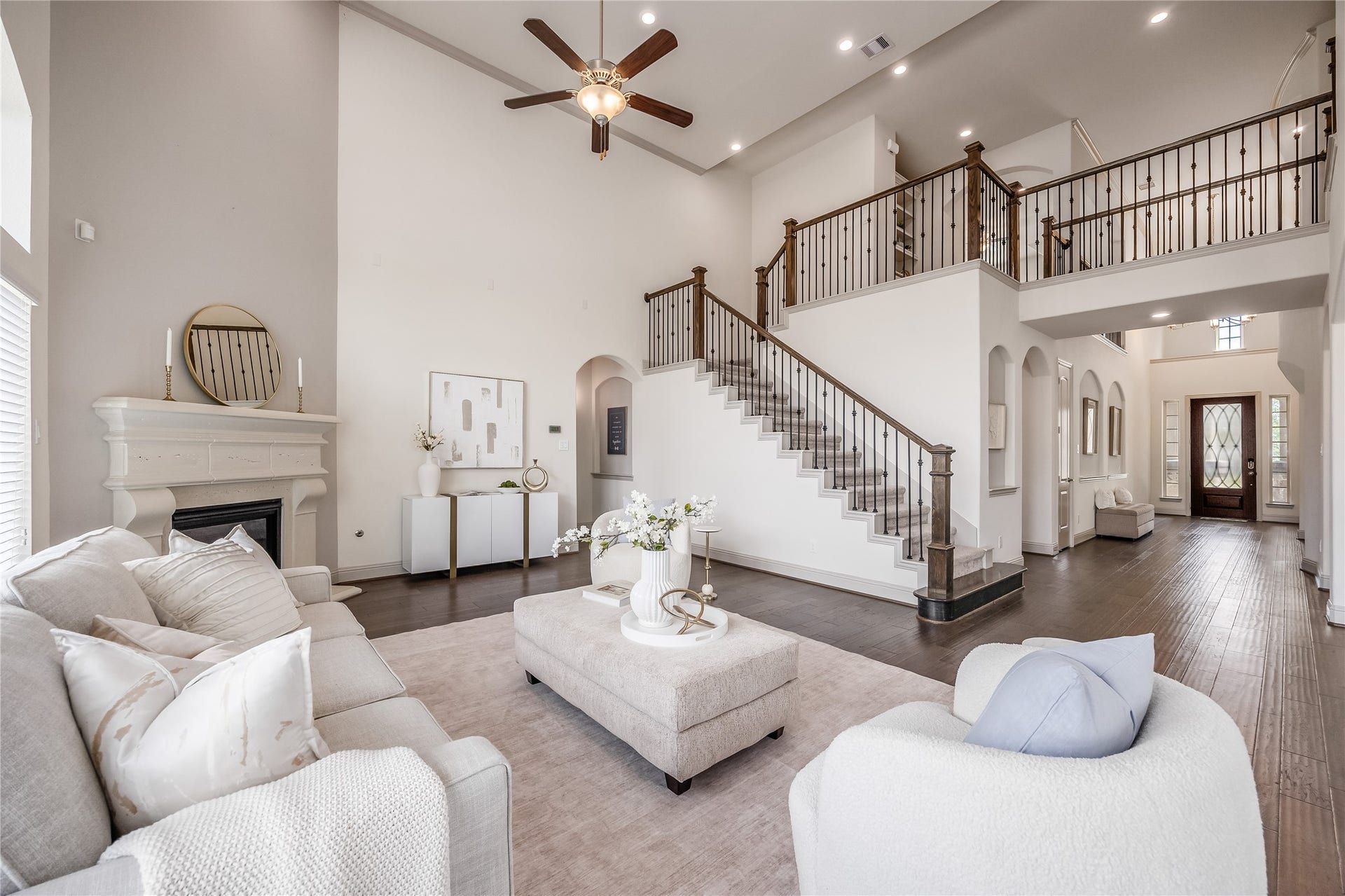 13506 COLUMBIA KEY Drive, Tomball, TX 77377 The sweeping staircase and open upper landing give this living room a grand feel, with plenty of space to gather below.