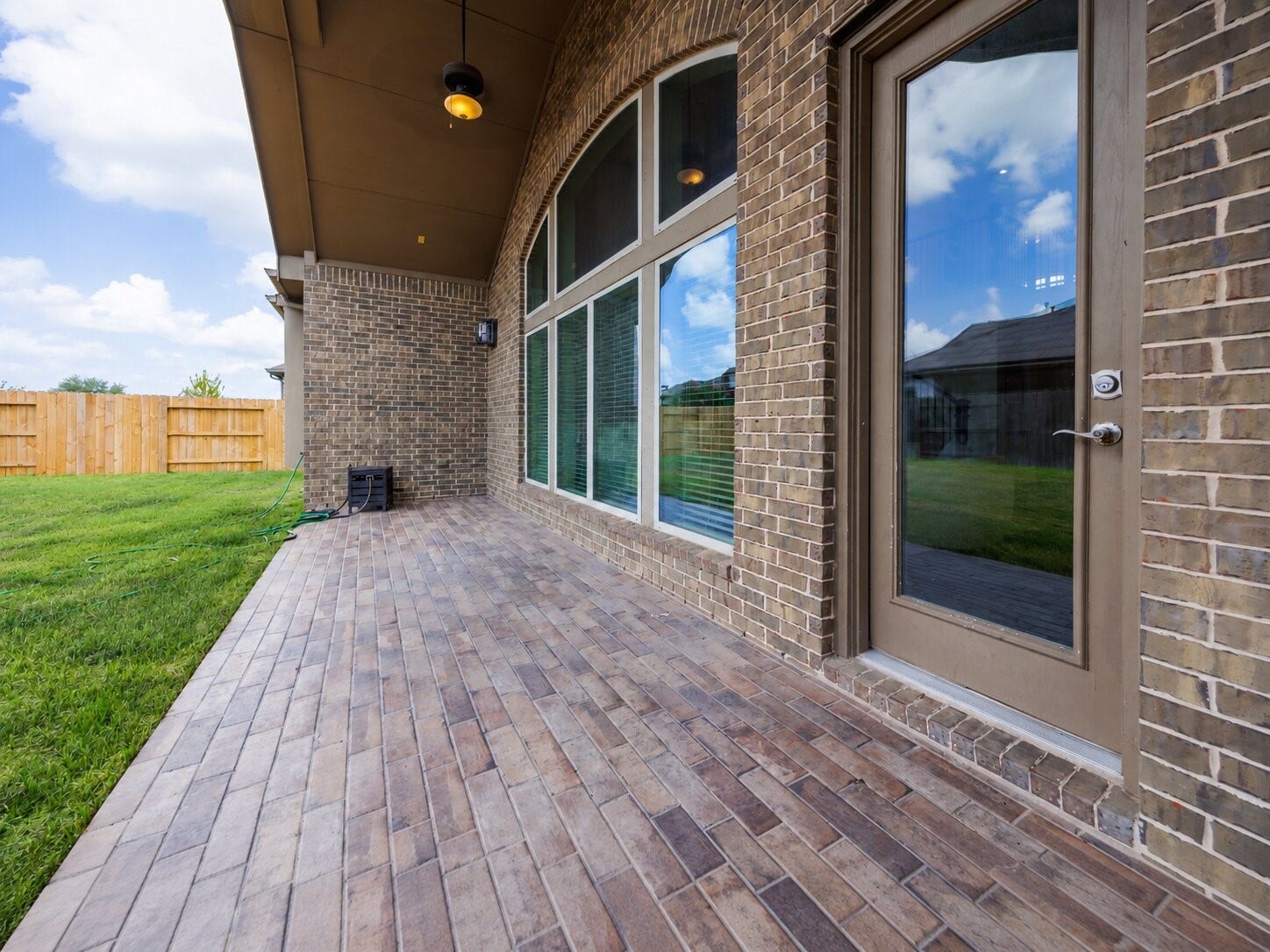 13506 COLUMBIA KEY Drive, Tomball, TX 77377 The covered back patio pairs tile flooring and a ceiling fan with room to relax outdoors, while four-sided brick adds lasting appeal.