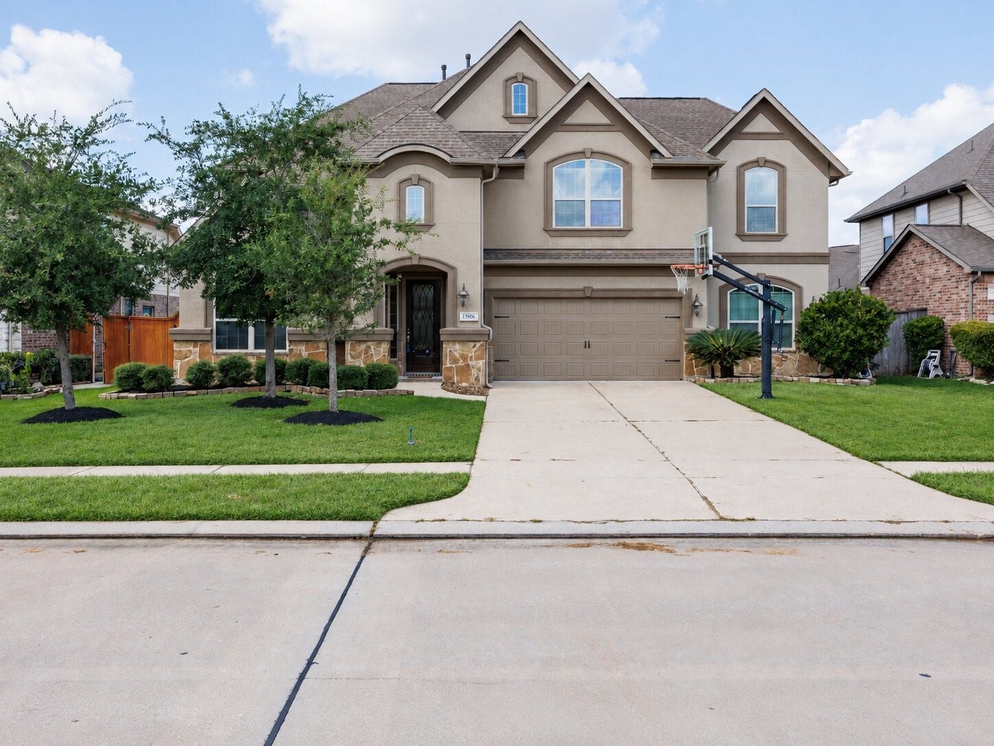 13506 COLUMBIA KEY Drive, Tomball, TX 77377 Arched details, stone accents, and a landscaped front yard give this home a memorable welcome.