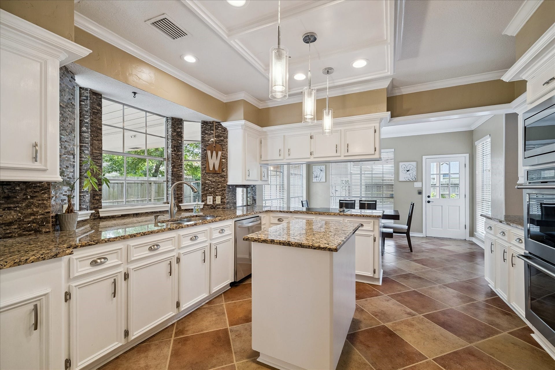 2919 Forest Garden Drive, Kingwood, TX 77345 Look at all the counte space filled with light from large windows.