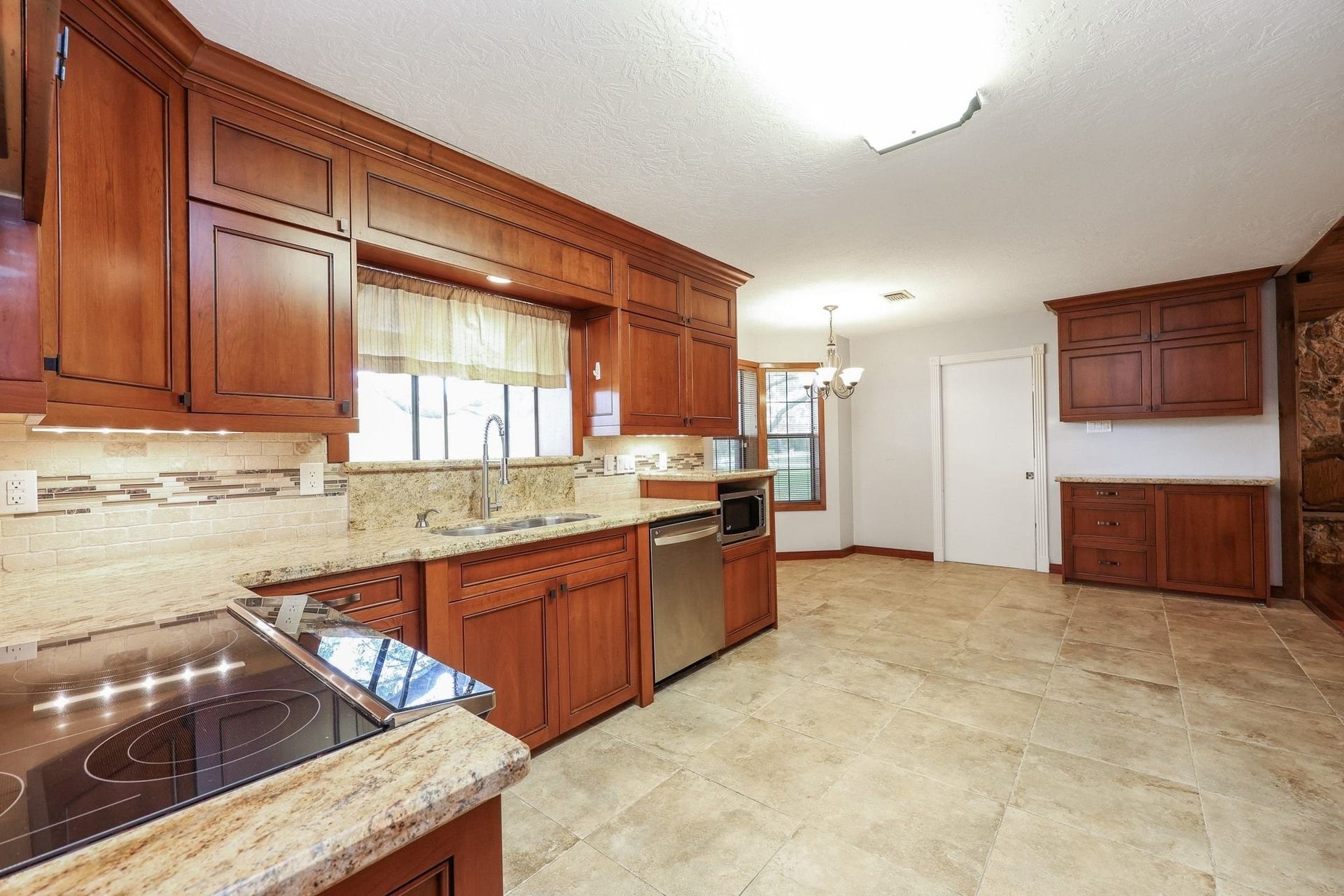 22107 Rosewood Trail, Tomball, TX 77377 Kitchen with Custom Cabinets, a Double Electric Oven, Pantry Storage, Microwave Shelf has Beautiful Views of the Neighborhood Lake
