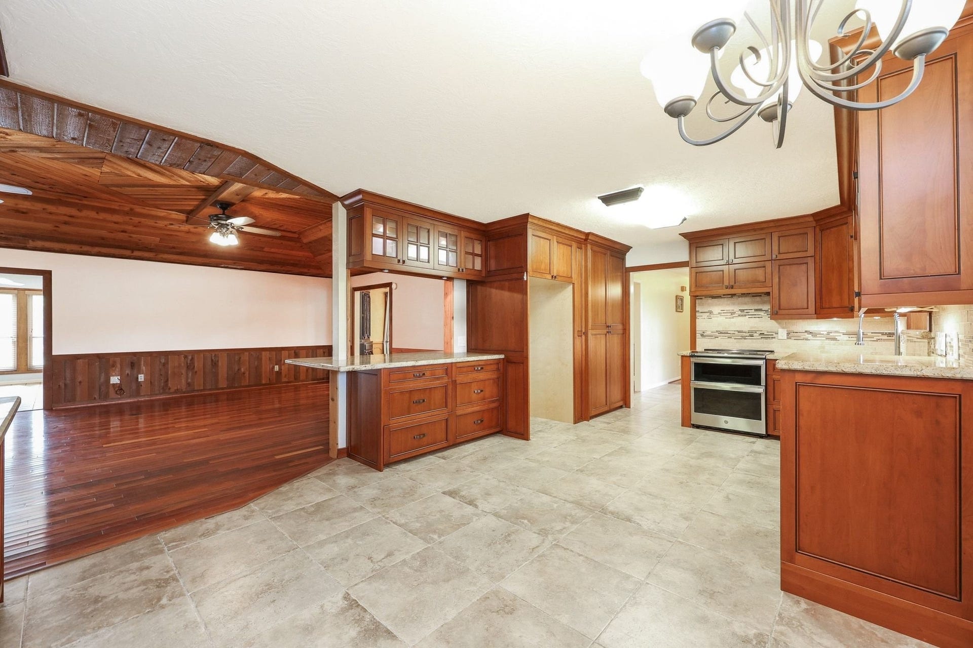 22107 Rosewood Trail, Tomball, TX 77377 Kitchen with Custom Cabinets, a Double Electric Oven, Pantry Storage, Microwave Shelf has Beautiful Views of the Neighborhood Lake