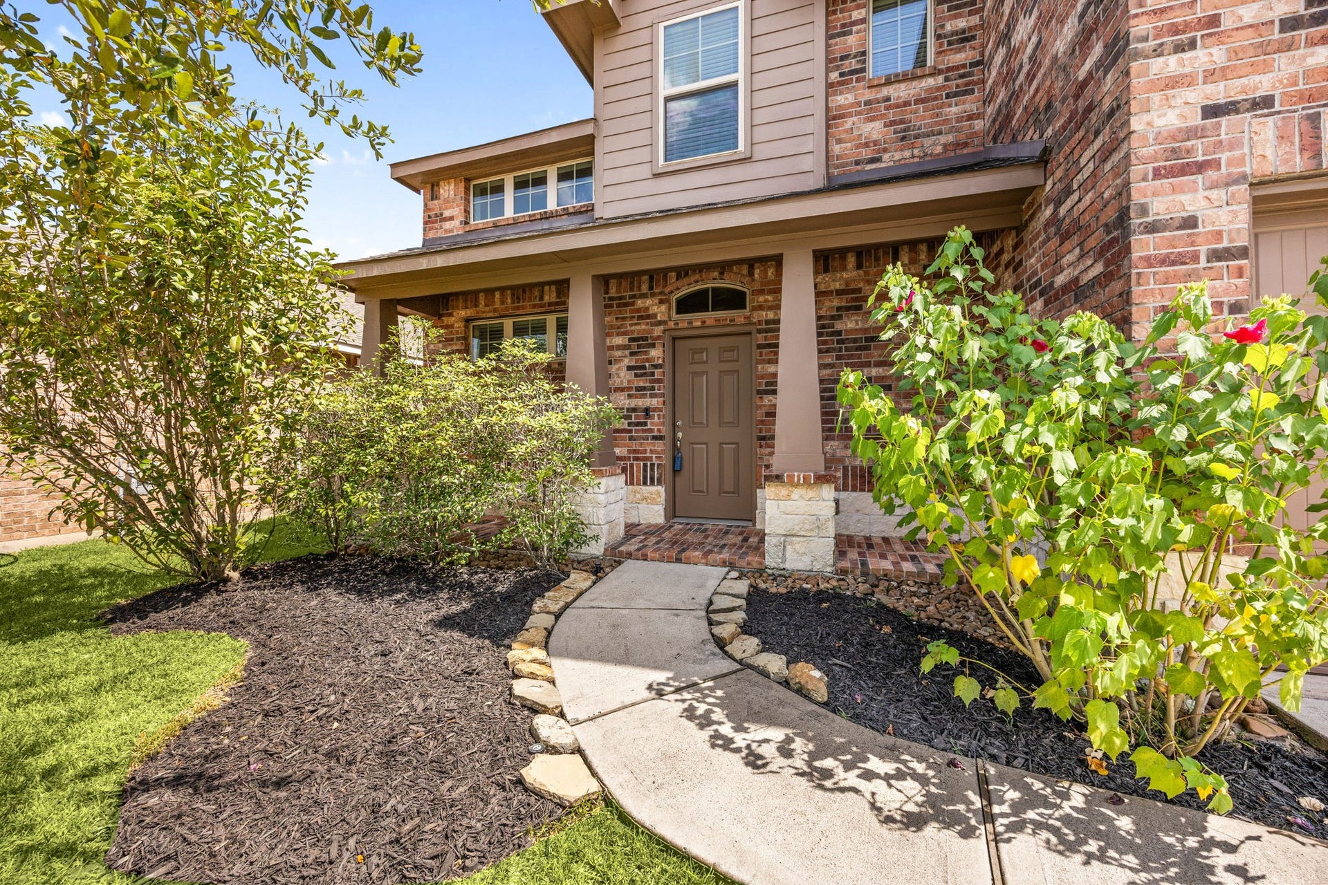 23643 Balzano Court, Katy, TX 77493 Charming covered front porch with manicured landscaping and a welcoming walkway creates the perfect first impression and a warm place to relax and enjoy the neighborhood.
