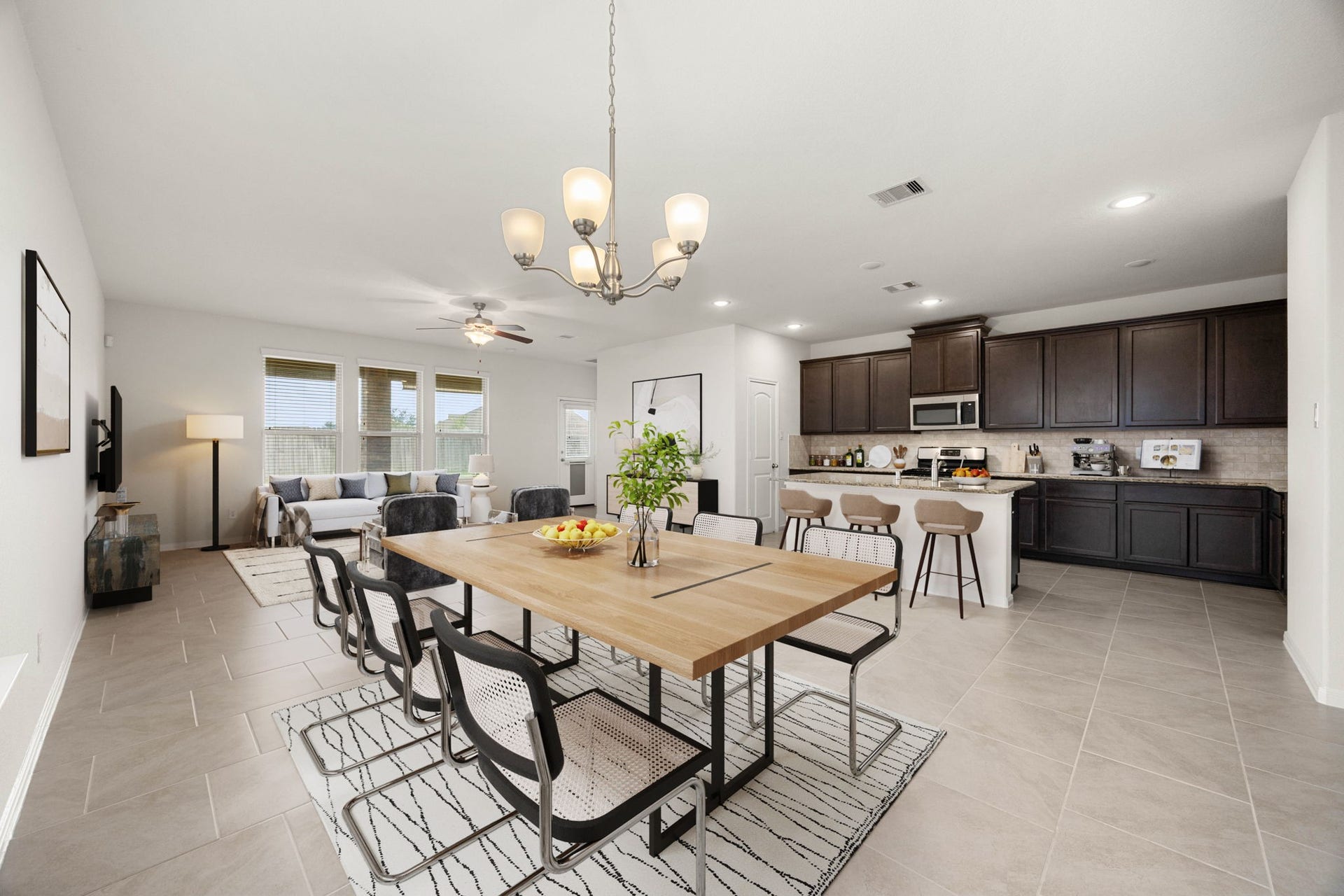 23643 Balzano Court, Katy, TX 77493 The spacious family room, dining area, and gourmet kitchen flow seamlessly together, creating the perfect space for entertaining or everyday living. Featuring an oversized island with seating, abundant cabinetry, and expansive windows overlooking the backyard, this home offers both style and functionality.