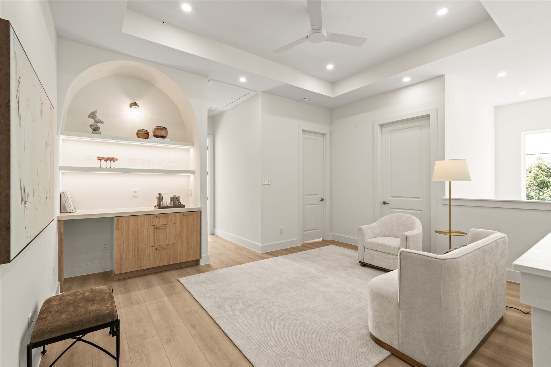 The upstairs game room, with a dry bar set into an arched, lit niche. Not a detail you find in most new builds at this price.