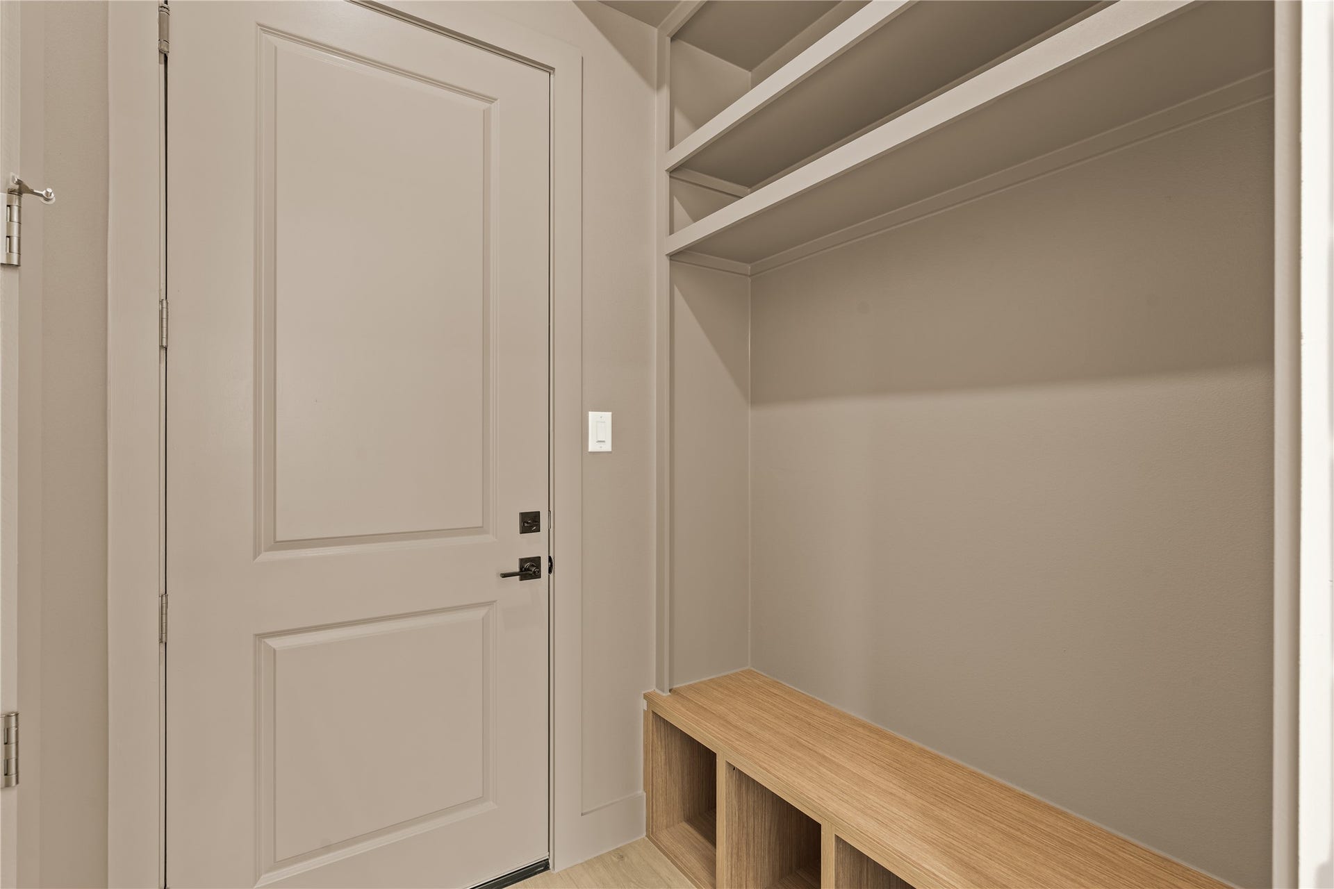 Mud room off the garage with a built-in bench, hooks, and cubbies. The drop zone on the way in, every single day.
