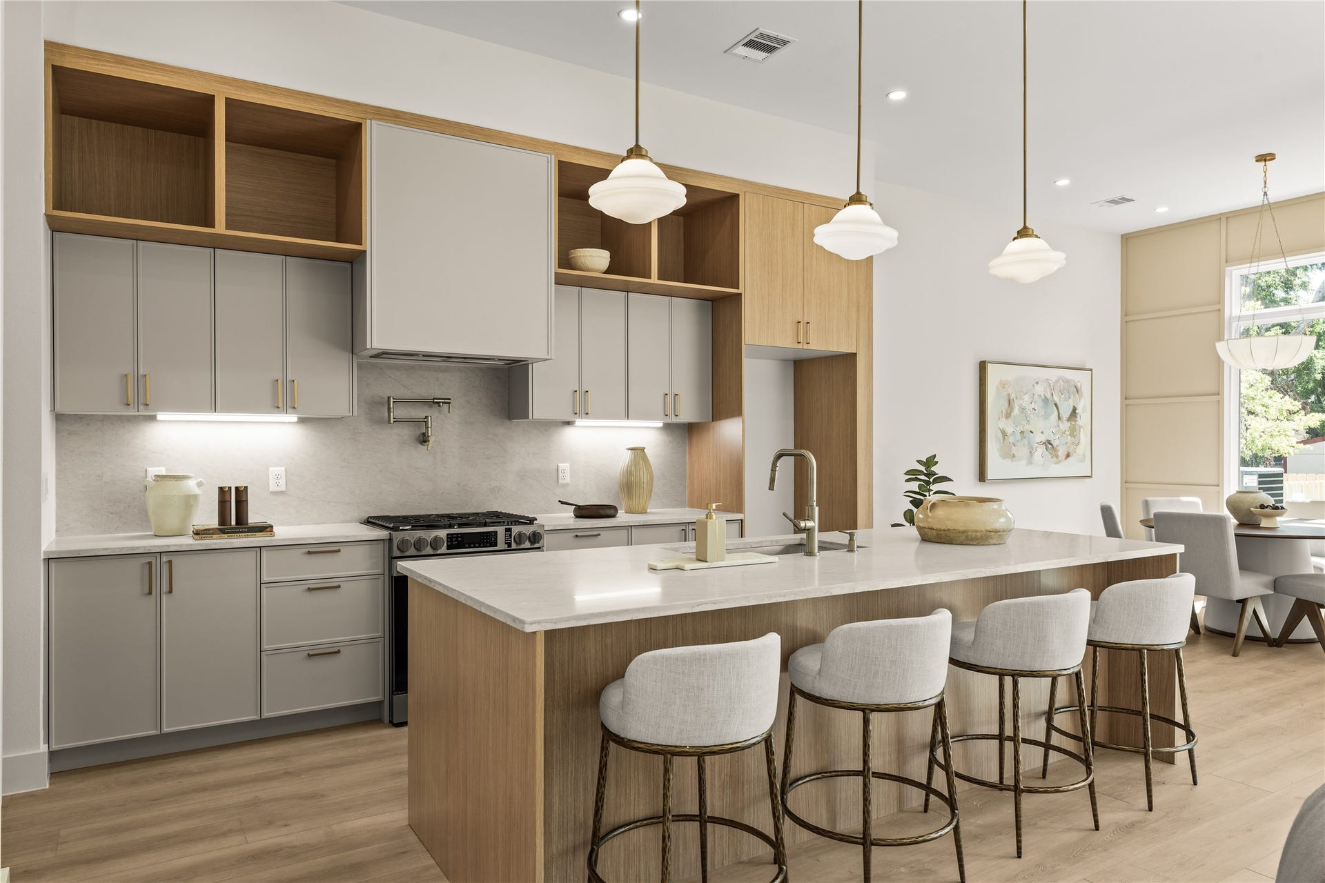 Island seating for four with the range and the window behind. Soft-close cabinets and drawers everywhere you touch.