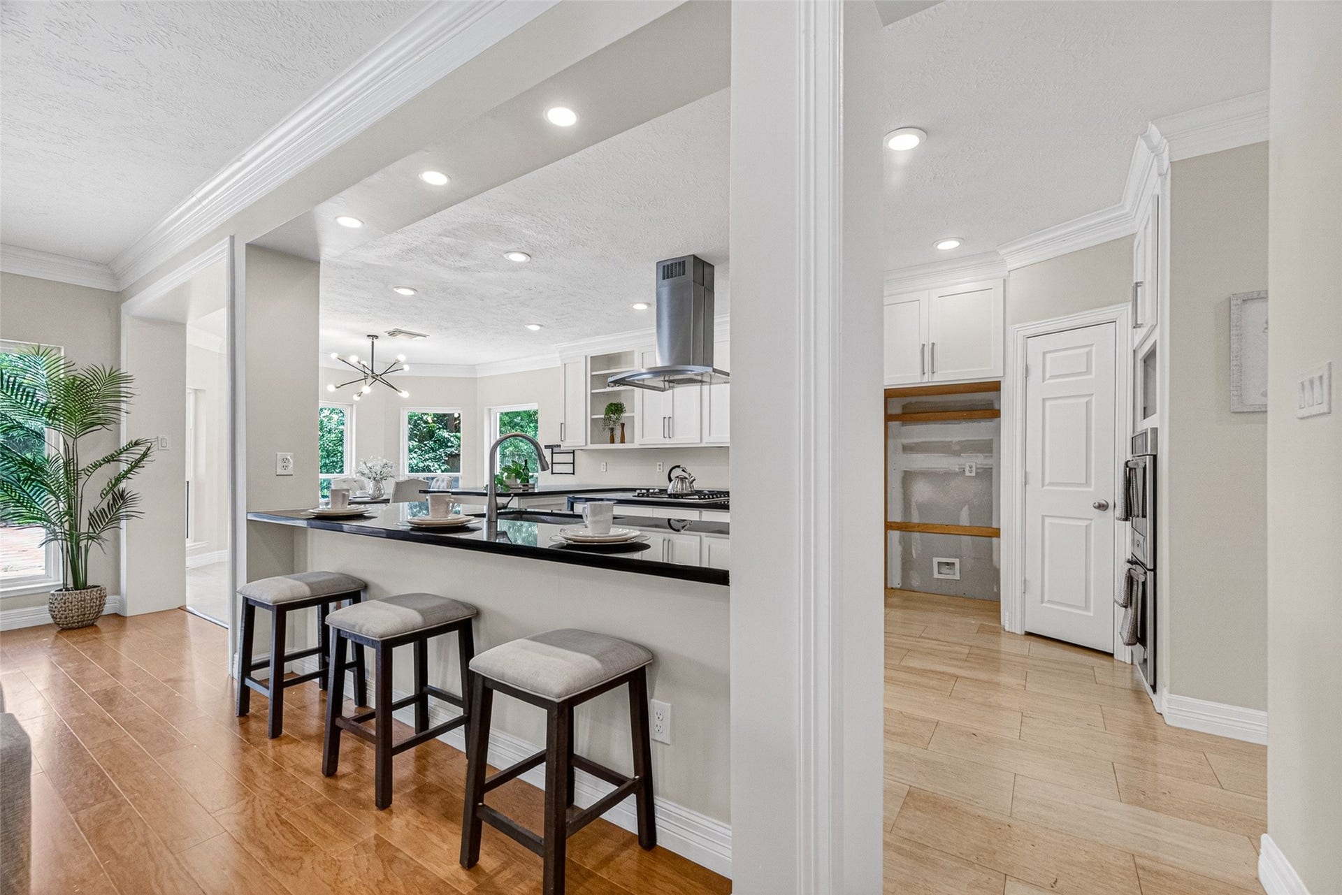 Spacious kitchen with sleek black countertops, modern stainless steel appliances, and a cozy breakfast bar.