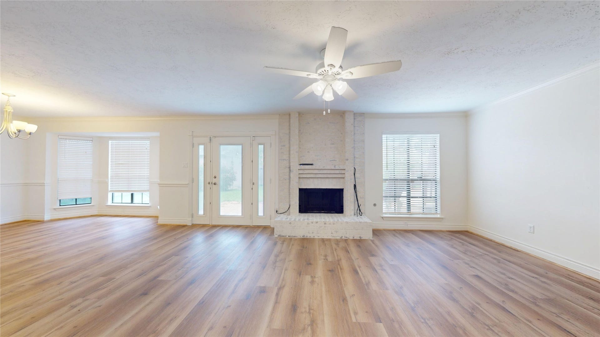 The spacious living room offers a warm and inviting setting with abundant natural light and a comfortable layout designed for both everyday living and entertaining.