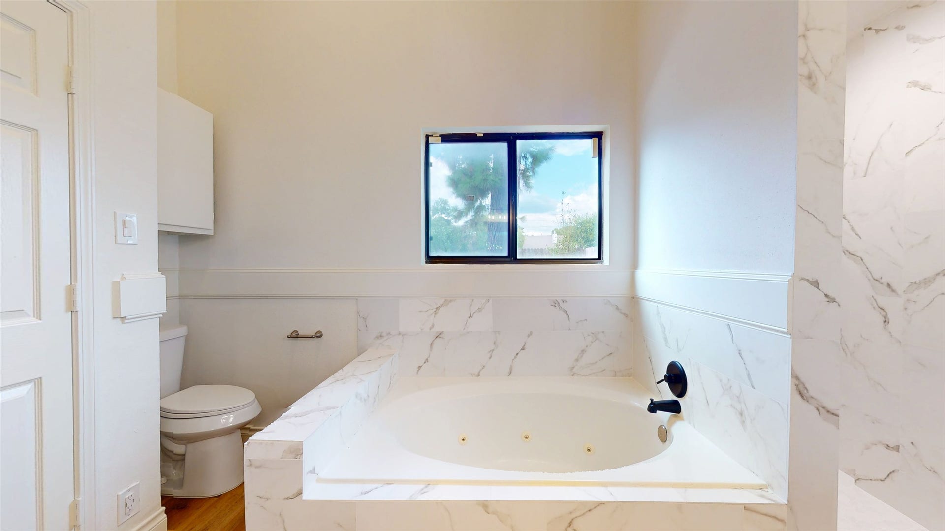 Two double-door closets offer generous clothing storage and complete this spacious primary retreat.