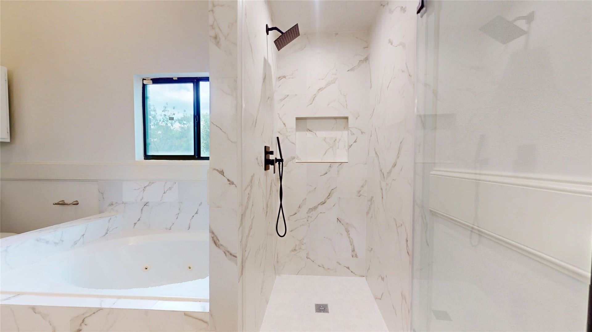 Separate walk-in shower offers a sleek, updated space with modern finishes.