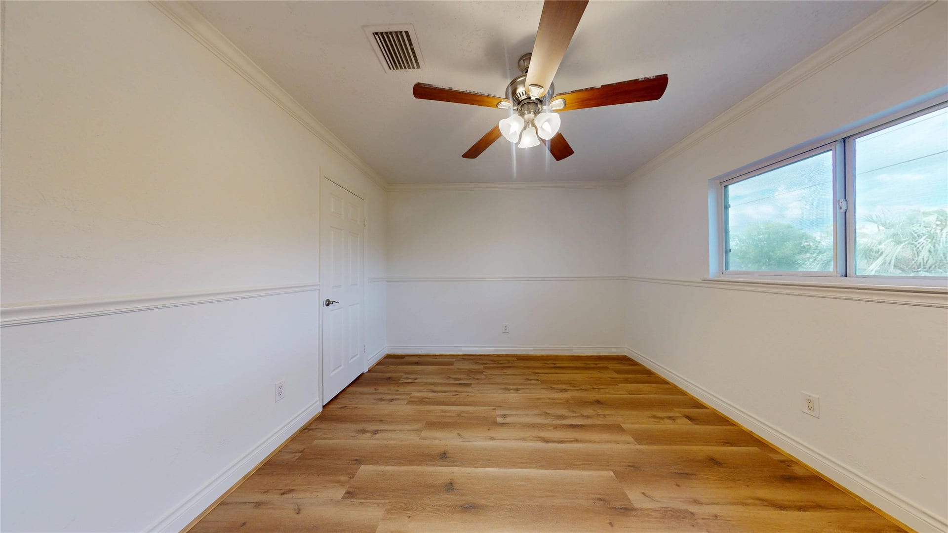 Spacious secondary bedroom with plenty of natural light and room for comfortable furnishings.