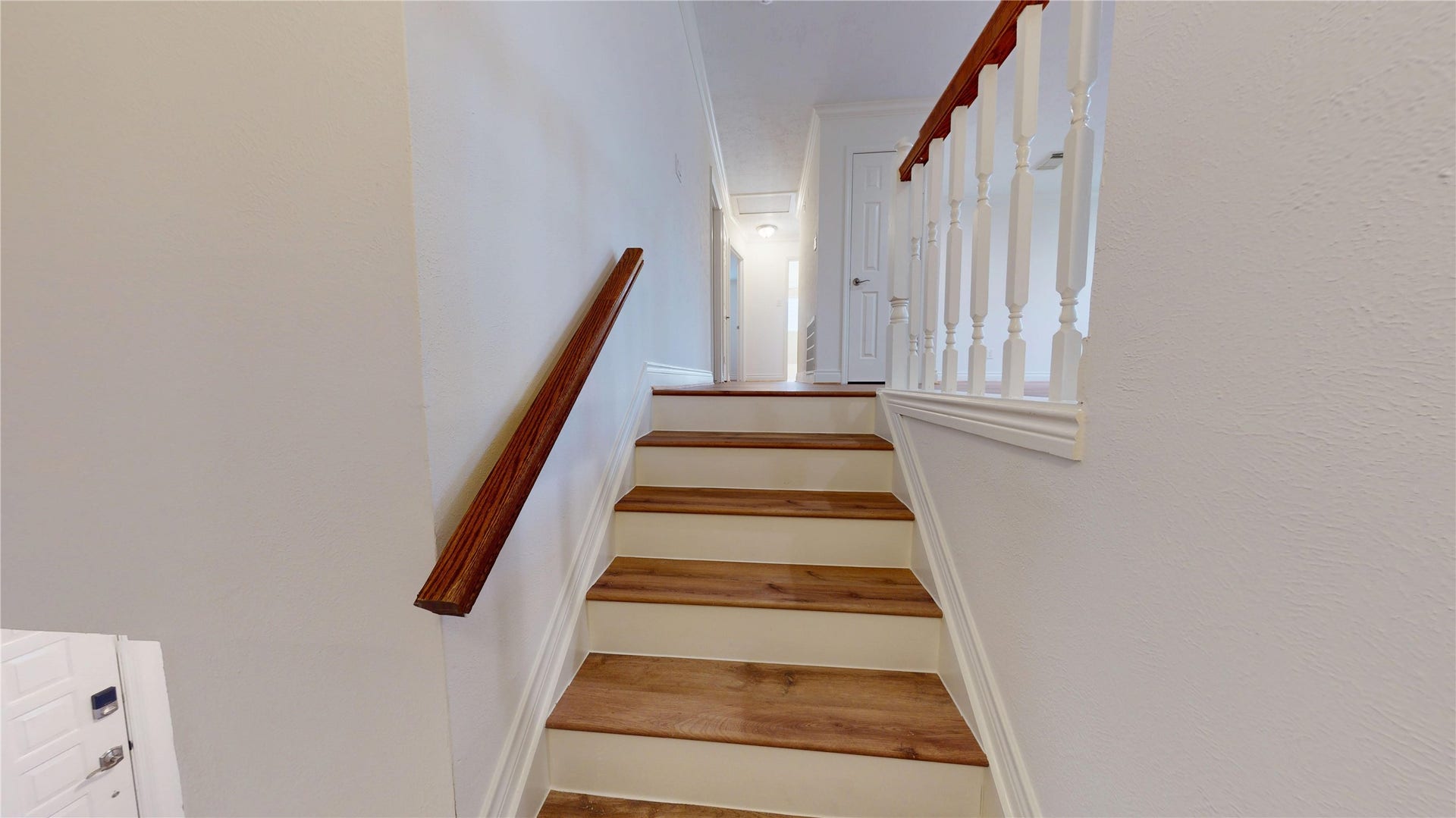 Newly remodeled stairs lead to the over-size game room and additional bedrooms.