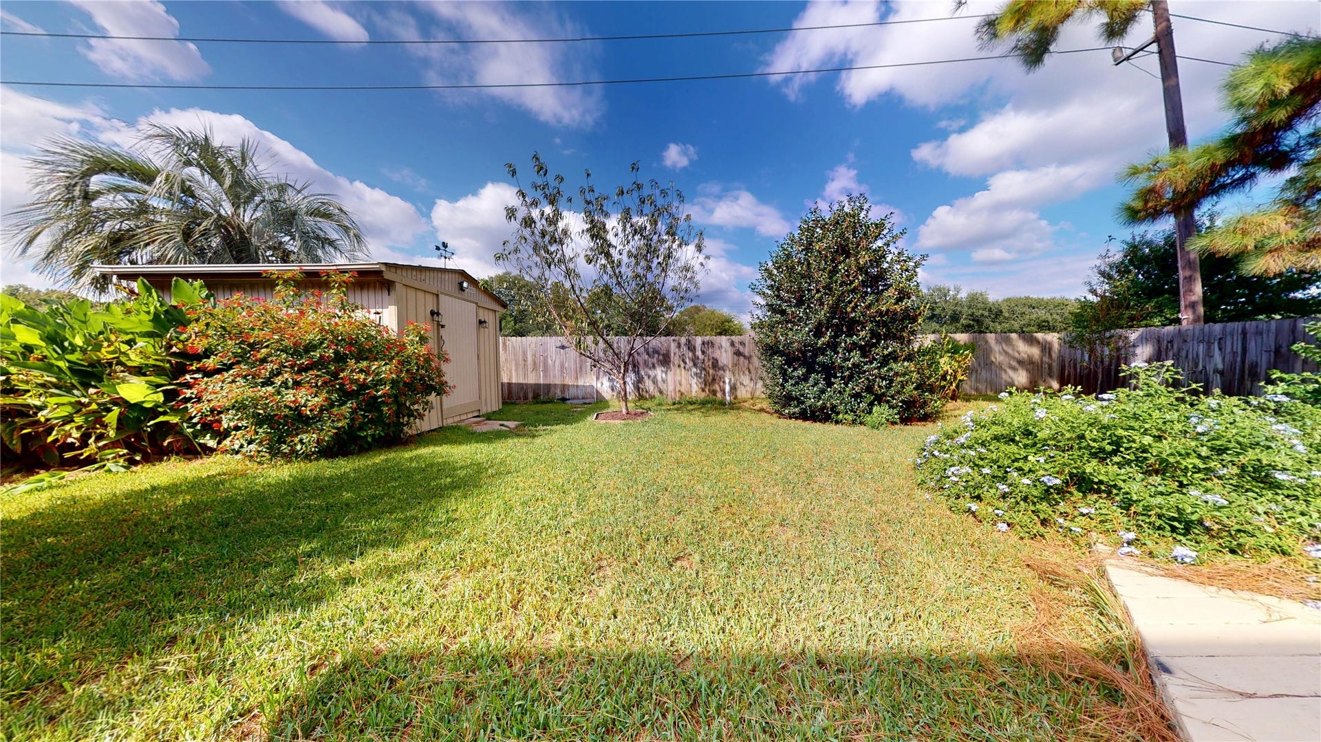 Convenient storage shed provides additional space for lawn equipment, tools, outdoor gear, and seasonal items.