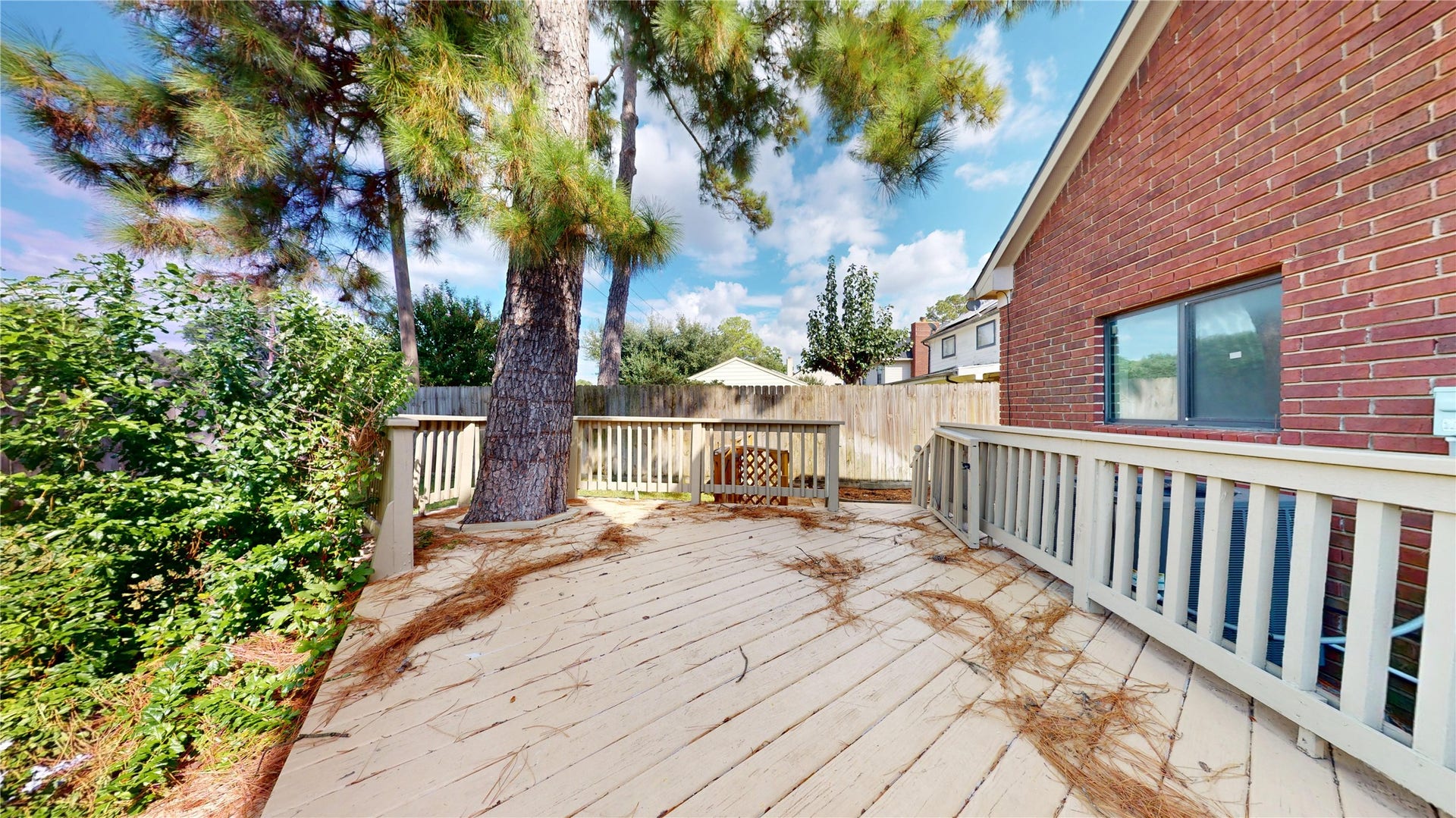 Beautifully refinished deck creates a fresh, inviting outdoor space perfect for relaxing or entertaining while overlooking the spacious backyard.