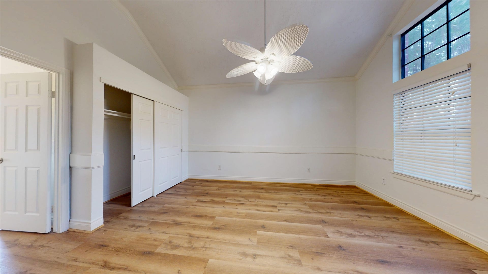 Bright and inviting primary retreat with a large sliding-door closet.