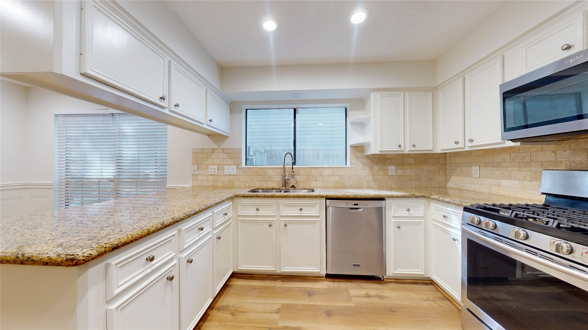 Spacious kitchen featuring ample cabinetry, counter space, and a large breakfast bar.