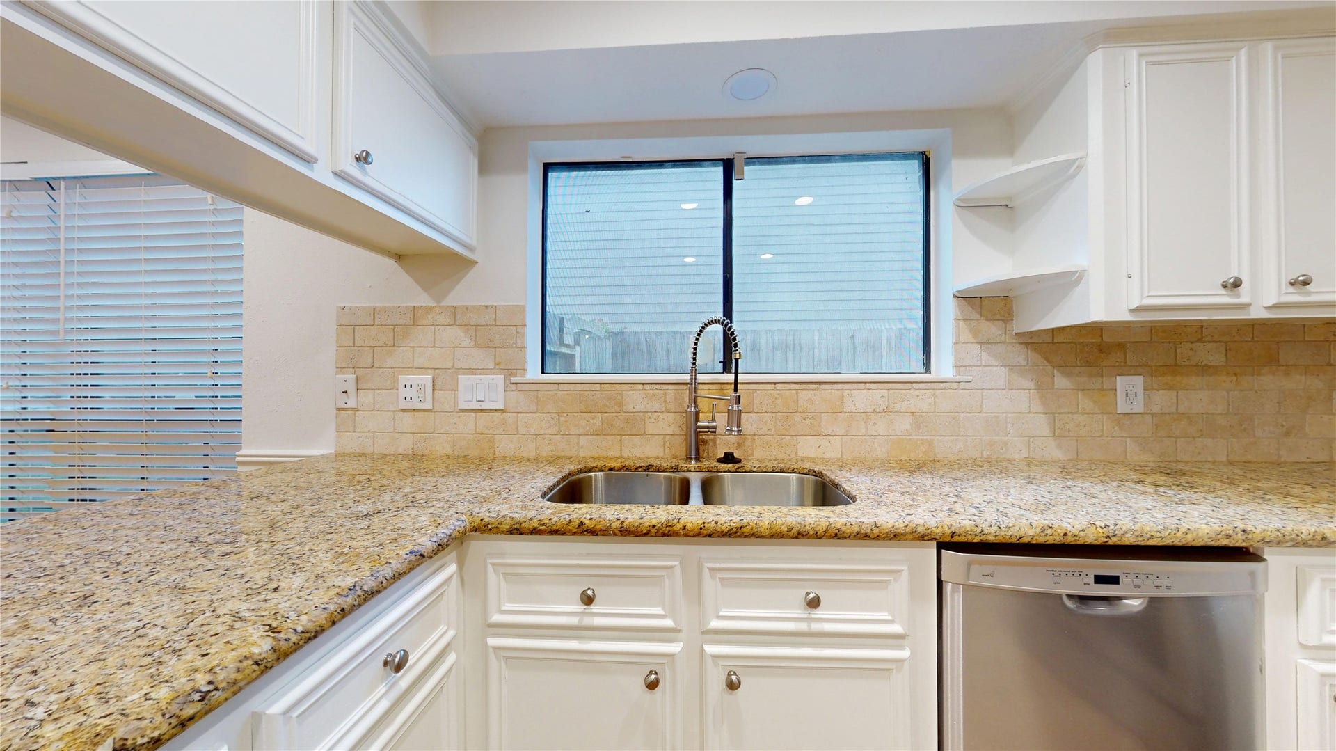 Spacious kitchen with granite counters, ample workspace, and a large breakfast bar for casual dining.