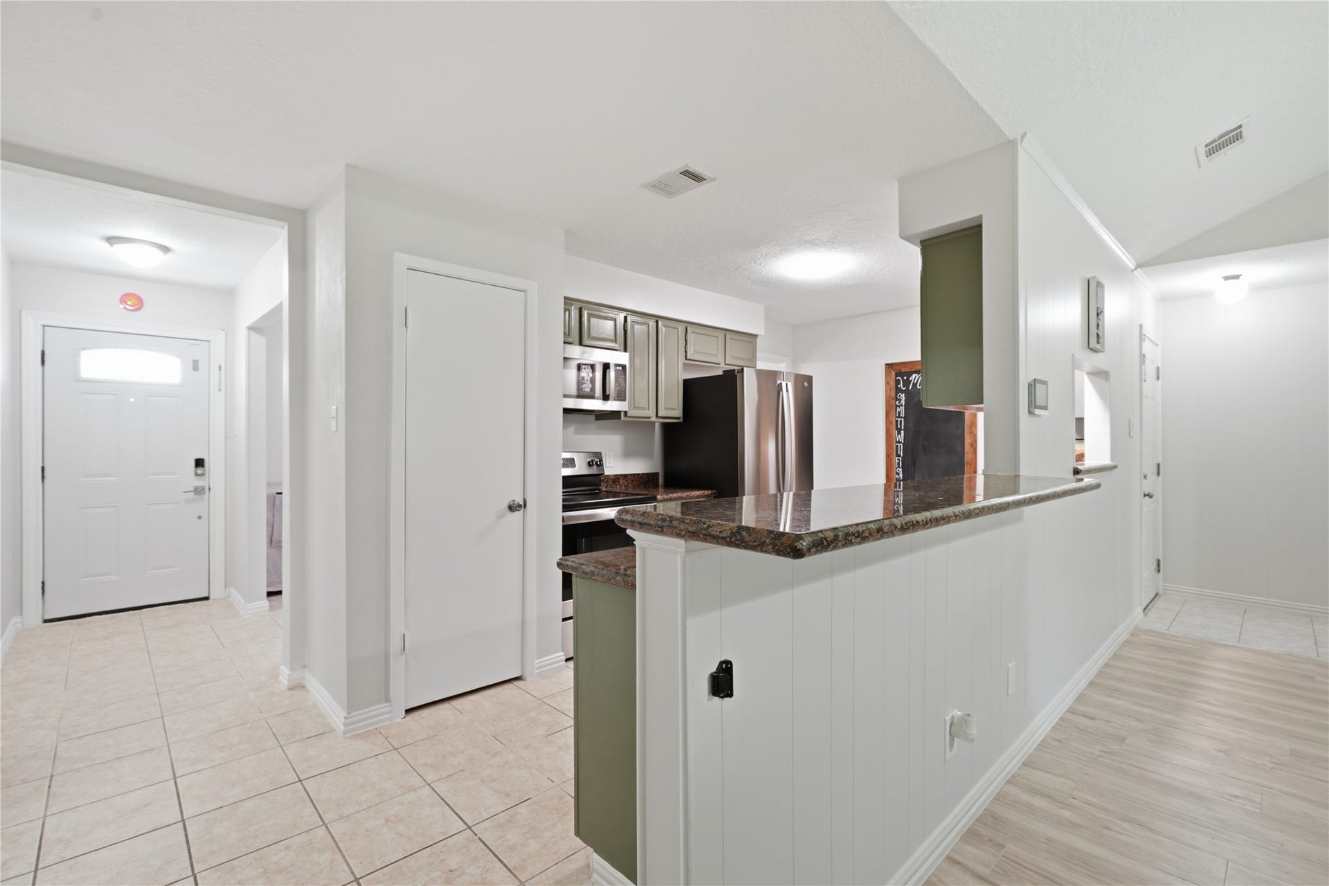 4850 Kentington Drive, Alvin, TX 77511 Open kitchen with an elevated breakfast bar, granite countertops, and easy flow into the main living areaideal for everyday living and entertaining.