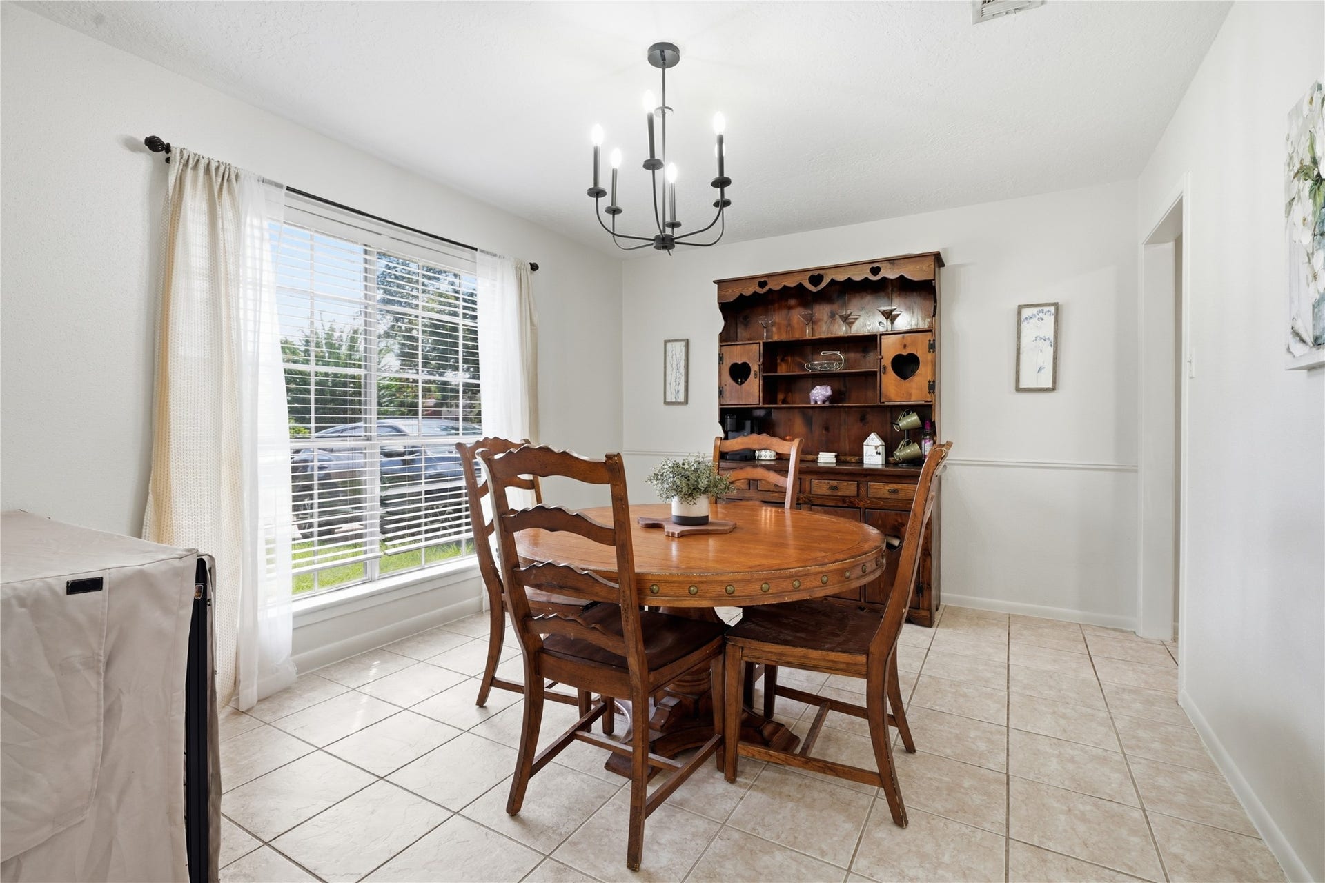 4850 Kentington Drive, Alvin, TX 77511 Spacious dining area with a large picture window, updated lighting, and plenty of room for meals and entertaining.