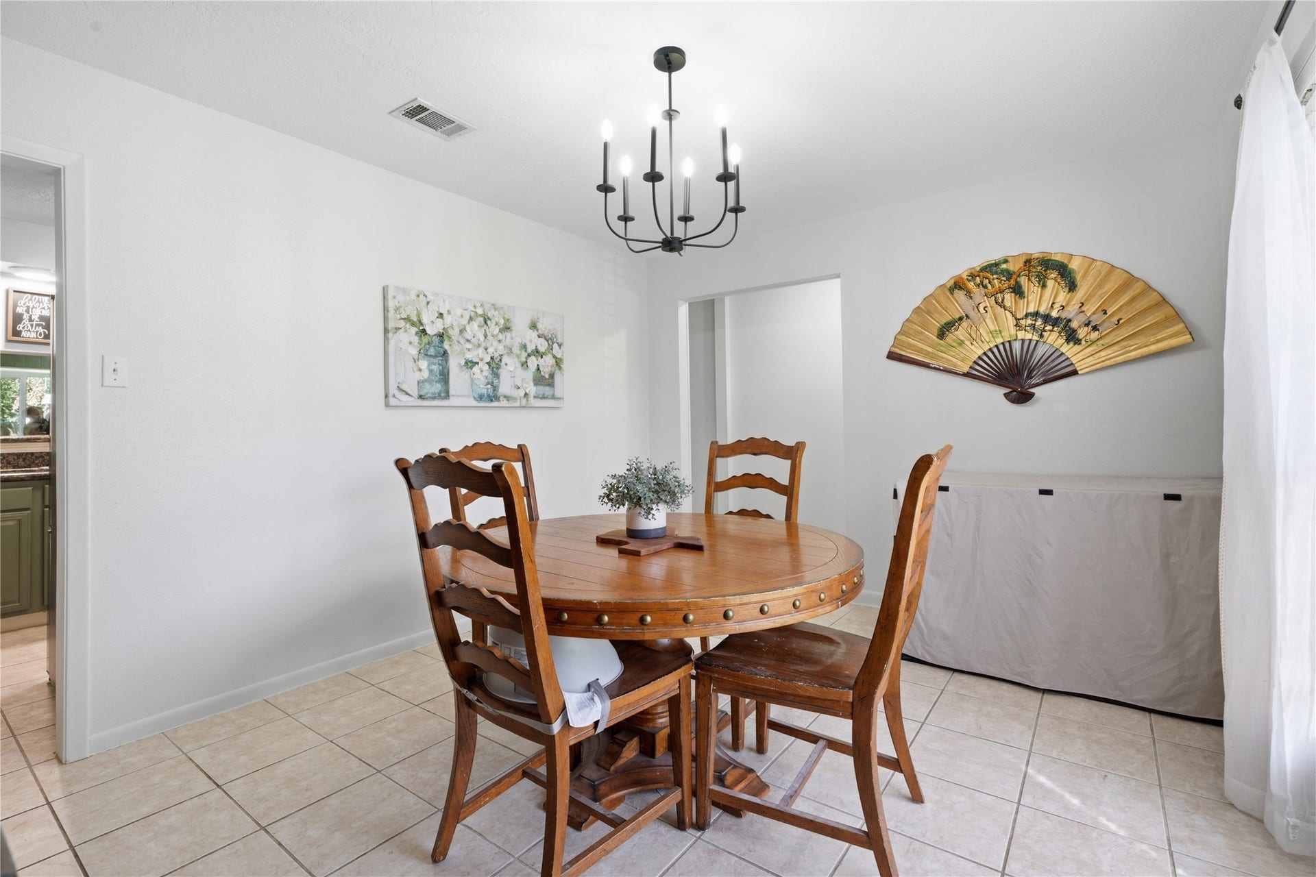 4850 Kentington Drive, Alvin, TX 77511 Dedicated dining room with abundant natural light, updated lighting fixture, and easy access to the kitchen.