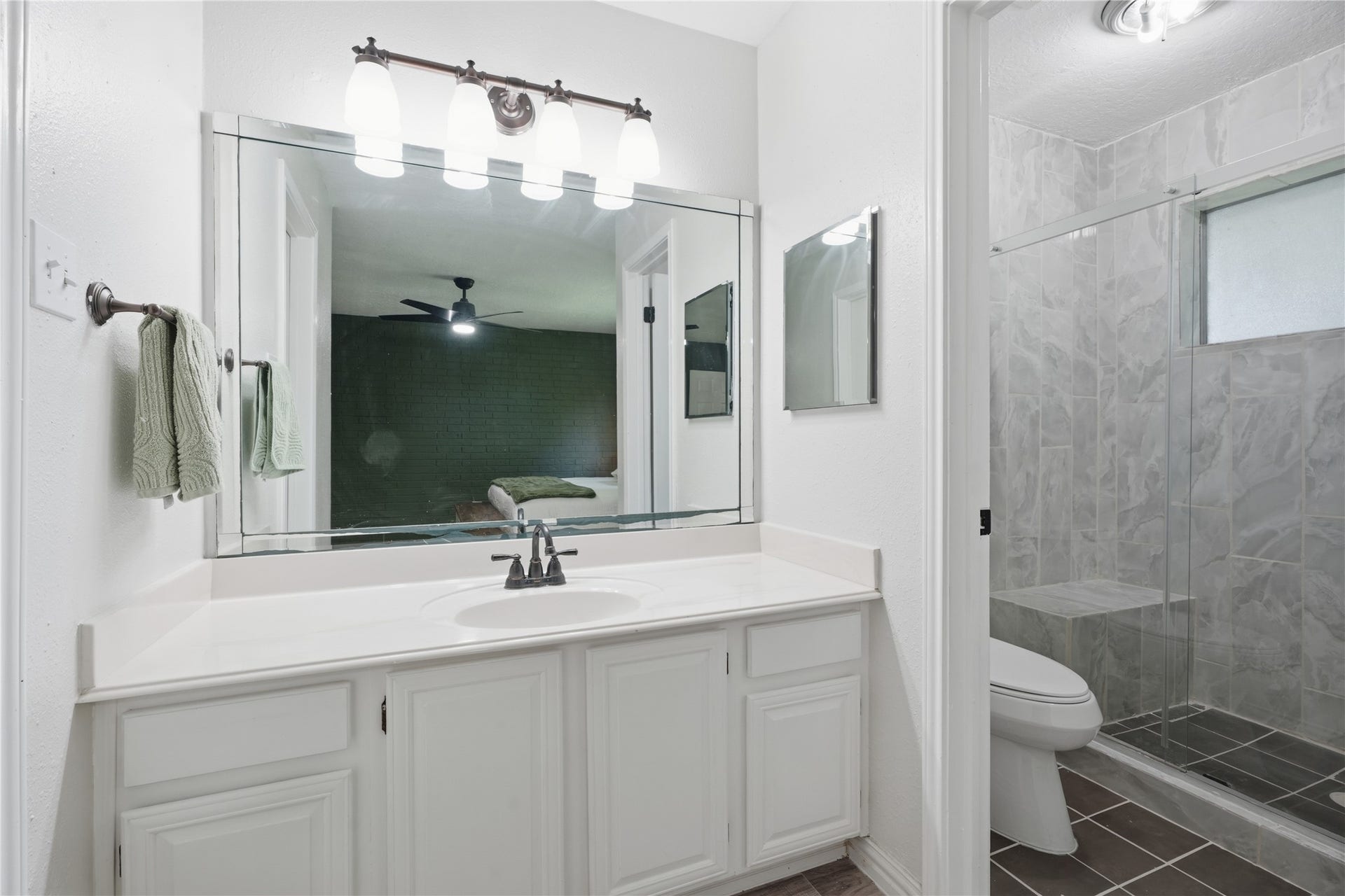 4850 Kentington Drive, Alvin, TX 77511 Primary bathroom featuring an oversized vanity with ample counter space, updated lighting, and direct access to the custom walk-in shower.