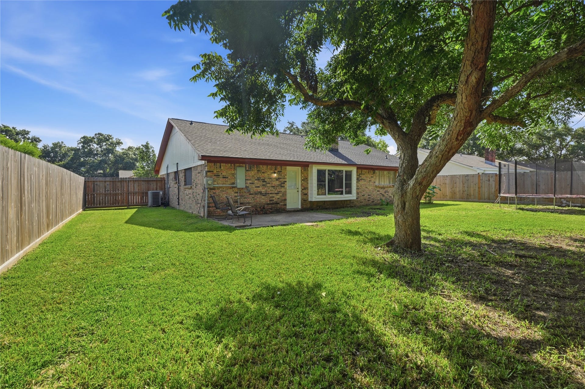 4850 Kentington Drive, Alvin, TX 77511 Enjoy a generous backyard complete with mature trees, a covered patio, and gated side-yard access.