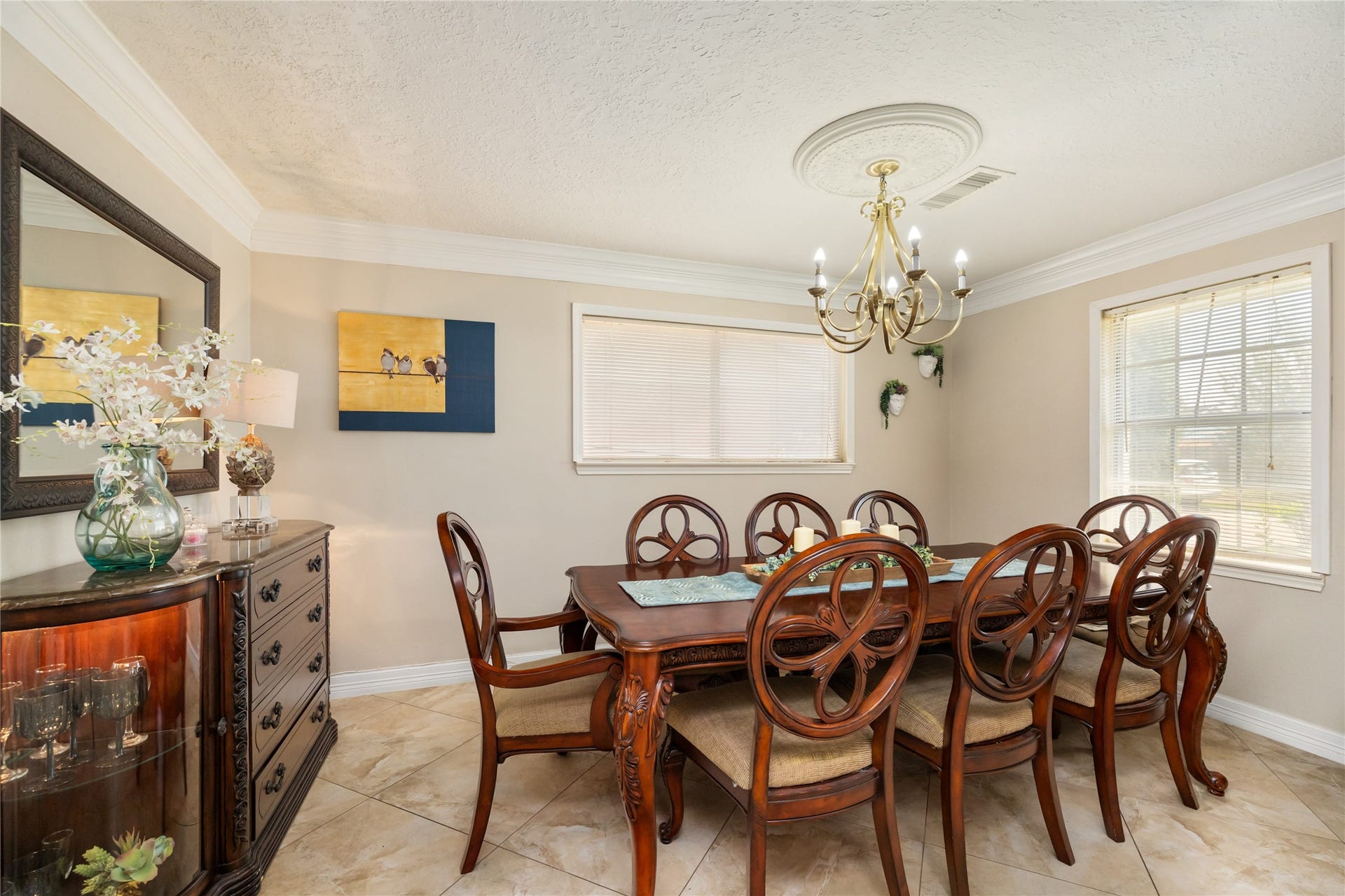 2603 Grape Lane, Pasadena, TX 77502 Large formal dinning room with crown molding and custom chandelier. Opens to receiving room.