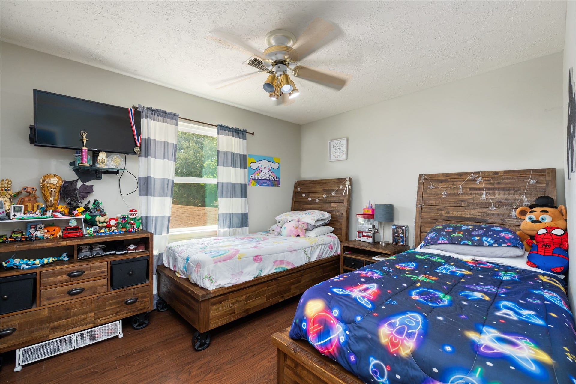 2603 Grape Lane, Pasadena, TX 77502 Large second bedroom with ample lighting and faux wood plank flooring.
