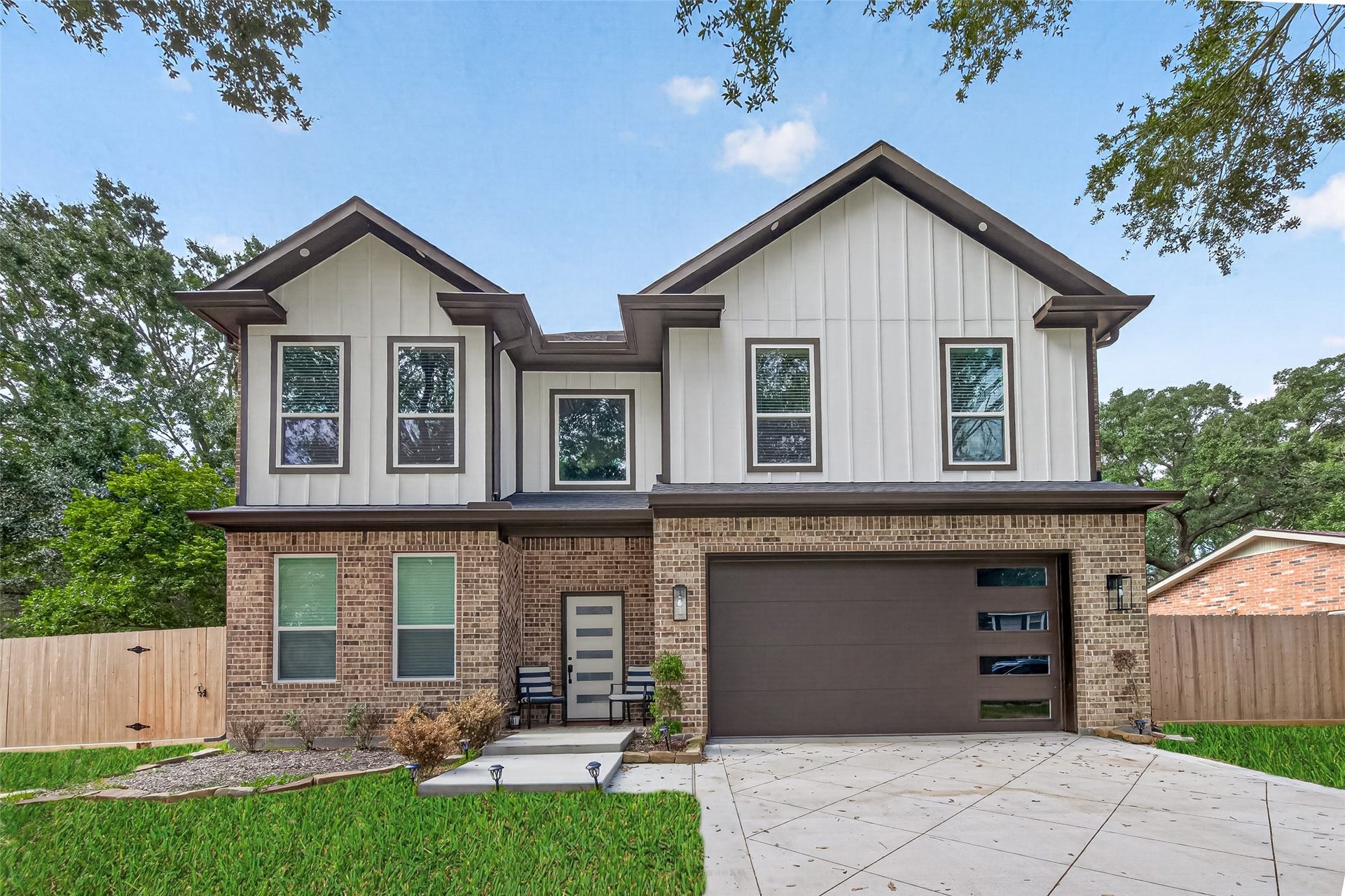 14807 Wallach Drive, Cypress, TX 77429 Stunning two-story home with a modern brick and siding exterior, featuring a spacious driveway and attached garage, nestled in a serene neighborhood.