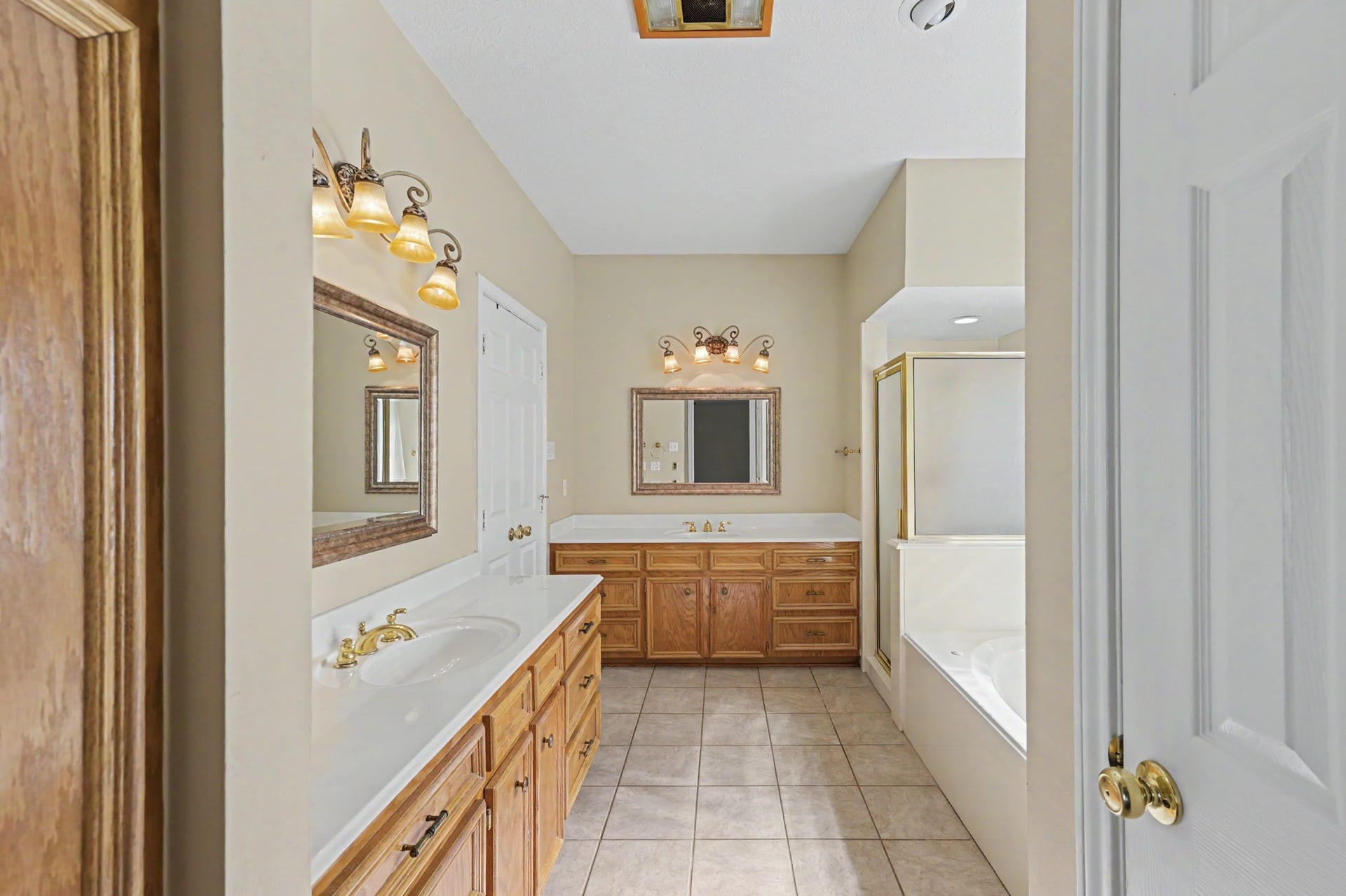 419 Dover Lane, Spring, TX 77373 Spacious primary bathroom with dual sinks and wooden cabinetry, a relaxing soaking tub, & separate shower. LOTS of storage throughout!
