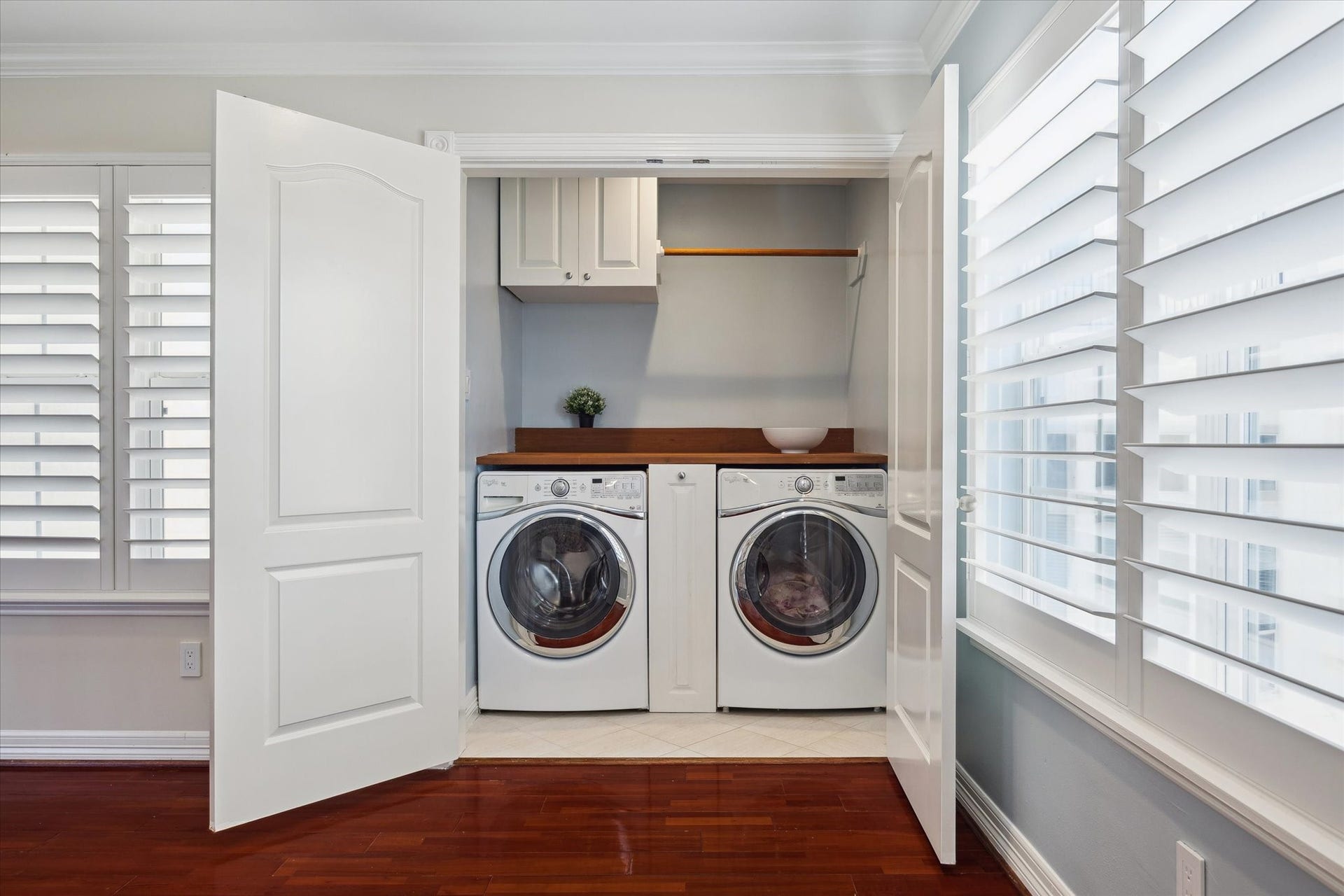 5717 Val Verde Street, #C, Houston, TX 77057 Compact, efficient laundry area neatly enclosed with practical shelving.