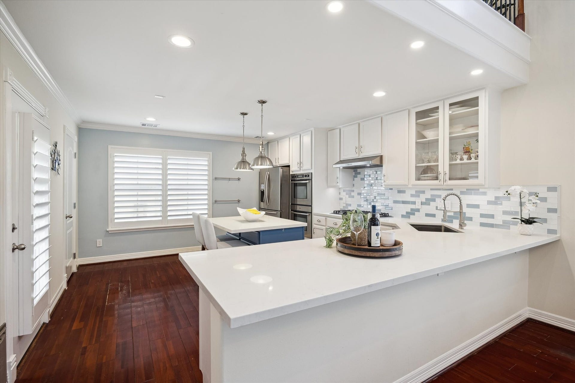 5717 Val Verde Street, #C, Houston, TX 77057 Updated kitchen with white cabinetry, stylish tile backsplash, and stainless steel appliances. It has a spacious island with seating. It opens to the dining/living room, easy for entertaining.