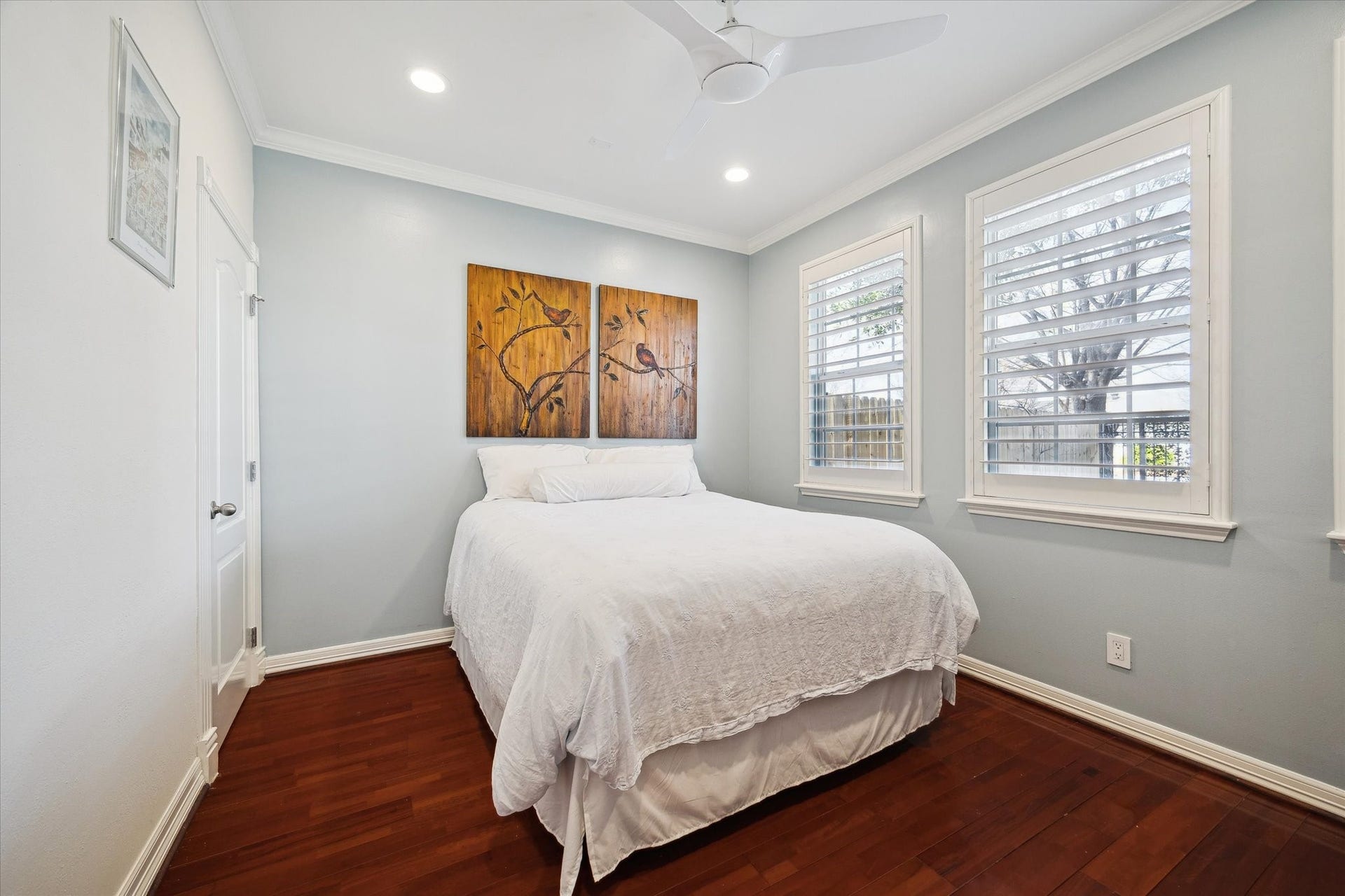 5717 Val Verde Street, #C, Houston, TX 77057 First floor bedroom features hardwood floors, a closet, and windows with plantation shutters overlooking the front yard. There is a second walk in closet in the hallway.