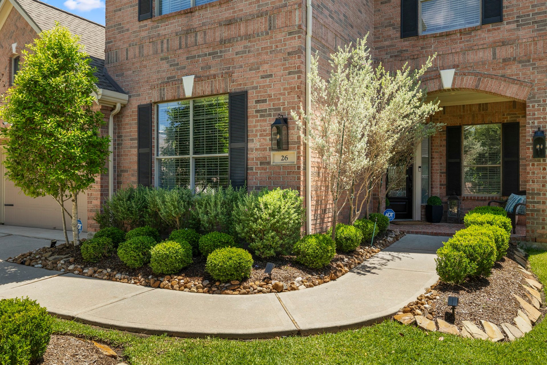 26 Winhall Place, The Woodlands, TX 77354 Step outside and the same attention to detail continues, with thoughtfully designed landscaping creating a welcoming approach to the home.