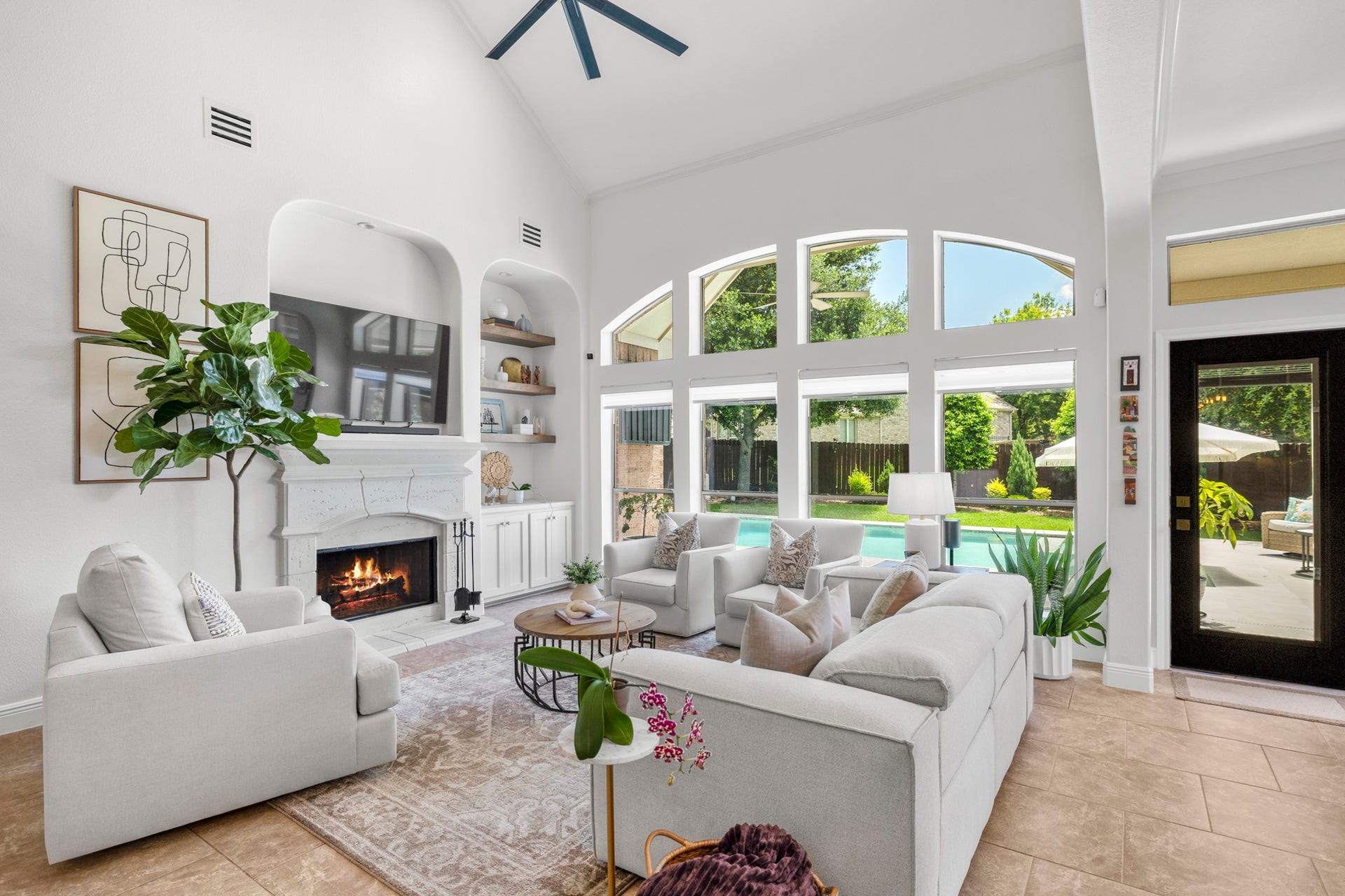 26 Winhall Place, The Woodlands, TX 77354 Walls of windows fill the living room with natural light and bring the outdoors in, creating a space that feels bright and welcoming.