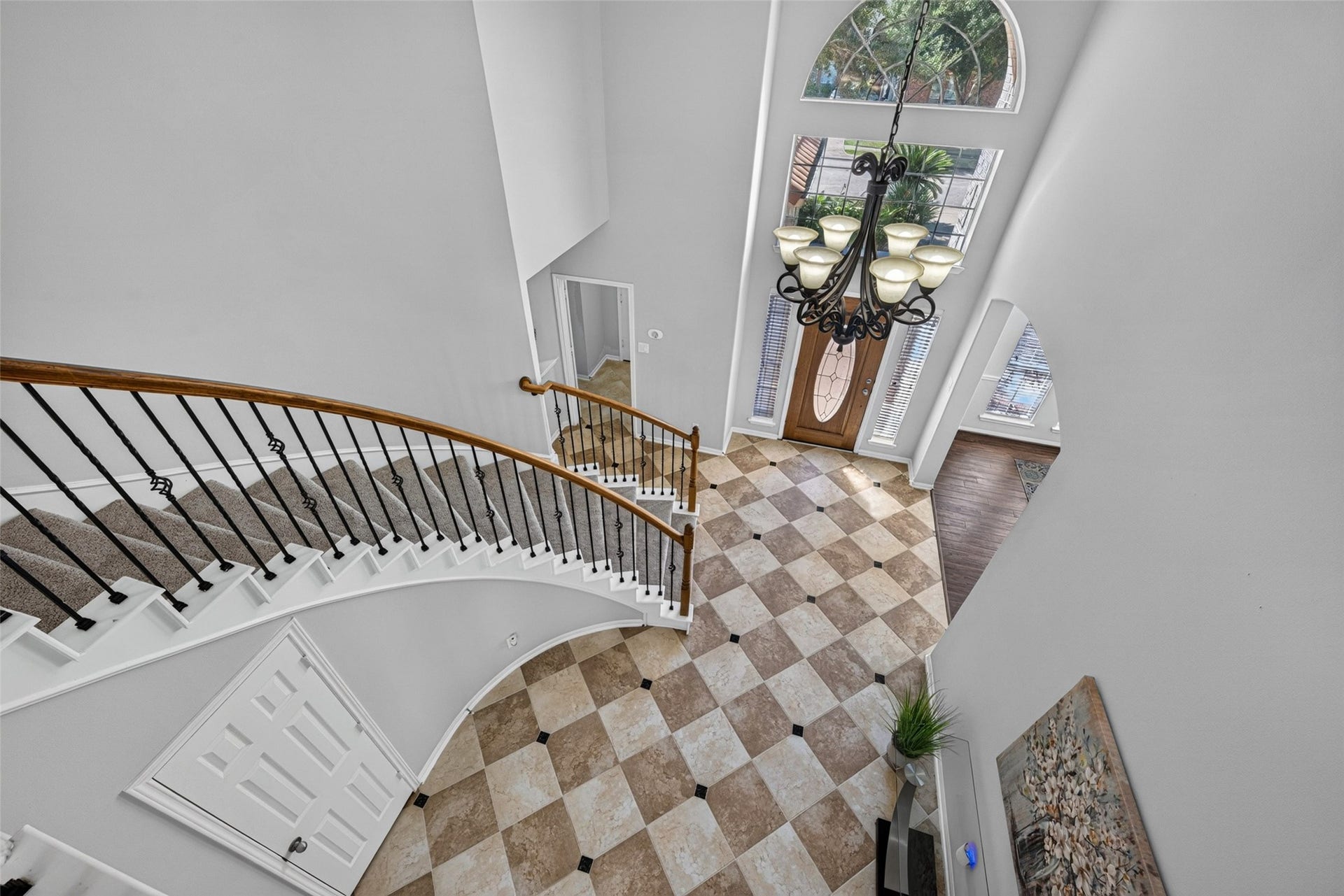 30 Palm Villas Drive, Manvel, TX 77578 Looking down from above, this dramatic two-story foyer showcases an impressive sweeping curved staircase and elegant soaring ceilings that create an immediate feeling of grandeur.