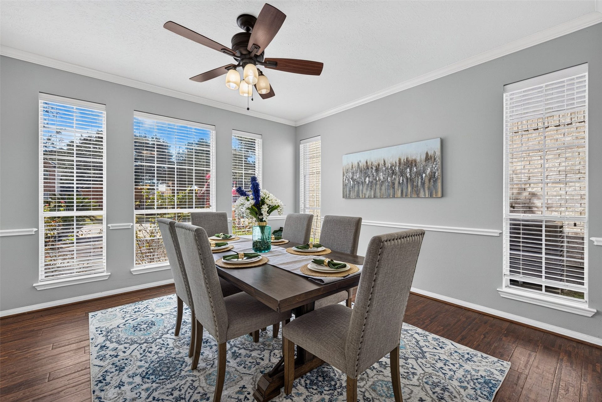 30 Palm Villas Drive, Manvel, TX 77578 Natural light pours through wide shuttered windows, casting a warm ambiance over holiday feasts and casual dinner parties alike.