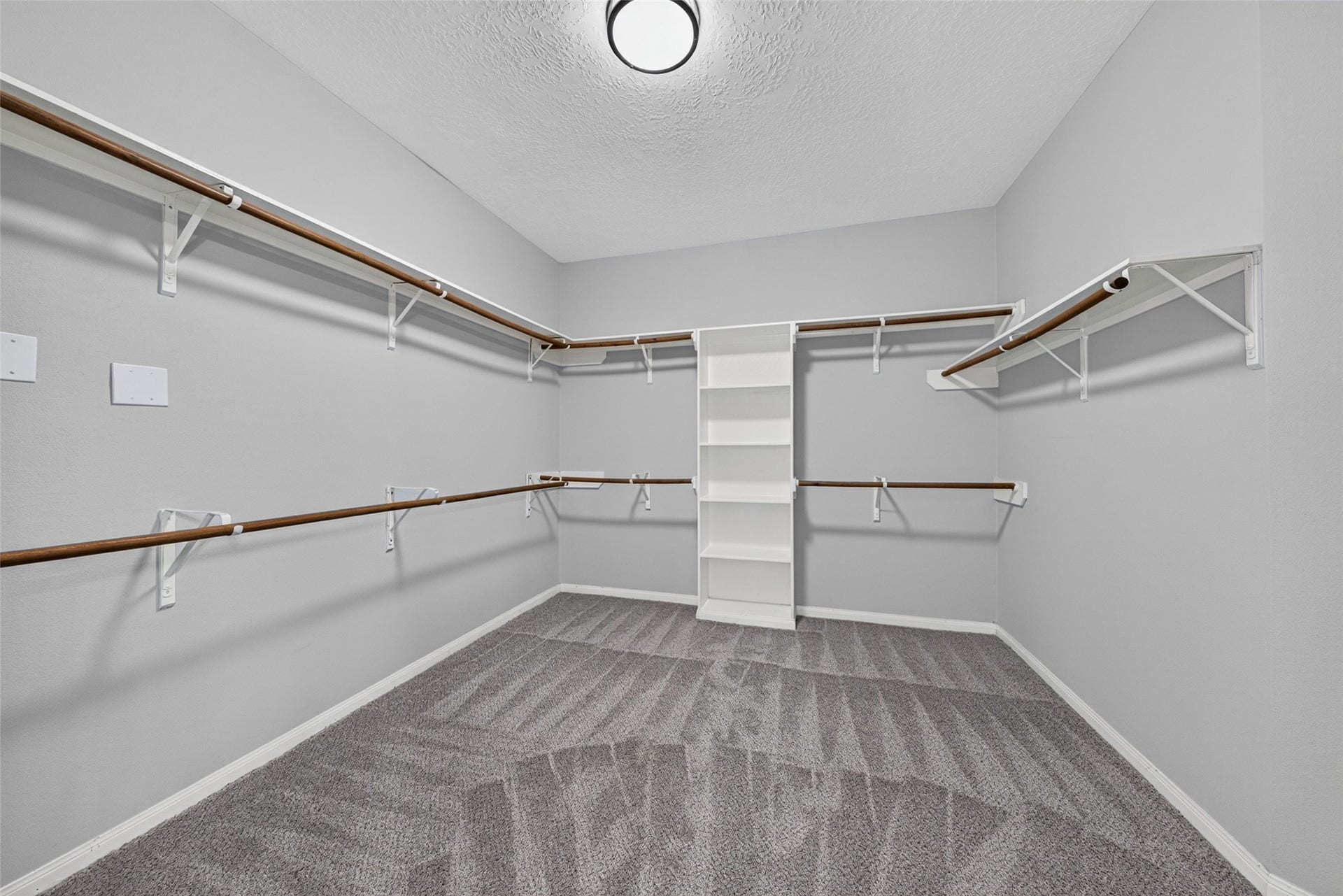 30 Palm Villas Drive, Manvel, TX 77578 Expansive and brilliantly organized, this primary walk-in closet is equipped with custom built-in shelving, multi-level hanging rods, and specialized shoe storage cubbies.