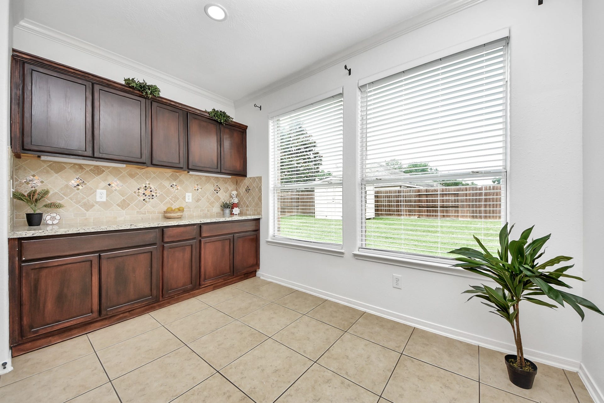 Storage lovers, take note! The breakfast nook offers more than just a place to gather, featuring additional counter space and upper and lower cabinetry that provide extra room for serving pieces and pantry overflow.