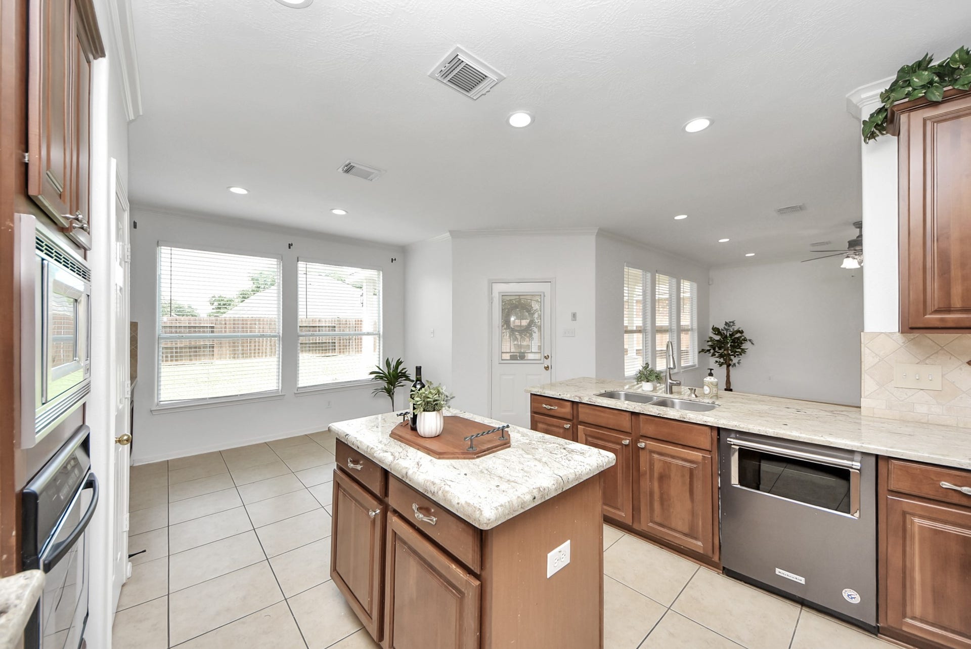 The kitchen island adds both function and convenience, offering extra storage and workspace while creating a natural gathering spot in the heart of the home.