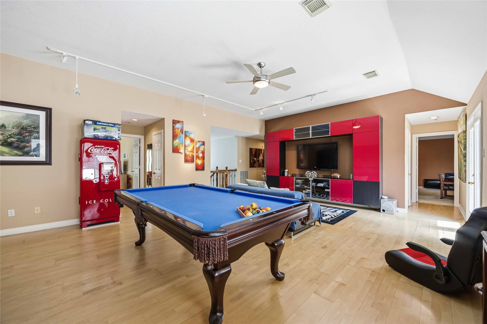 7610 Guinevere Drive, Sugar Land, TX 77479 This versatile entertainment space features an open layout with recessed media wall alcoves, structured wall cutouts, and multiple doorways connecting to adjacent rooms.