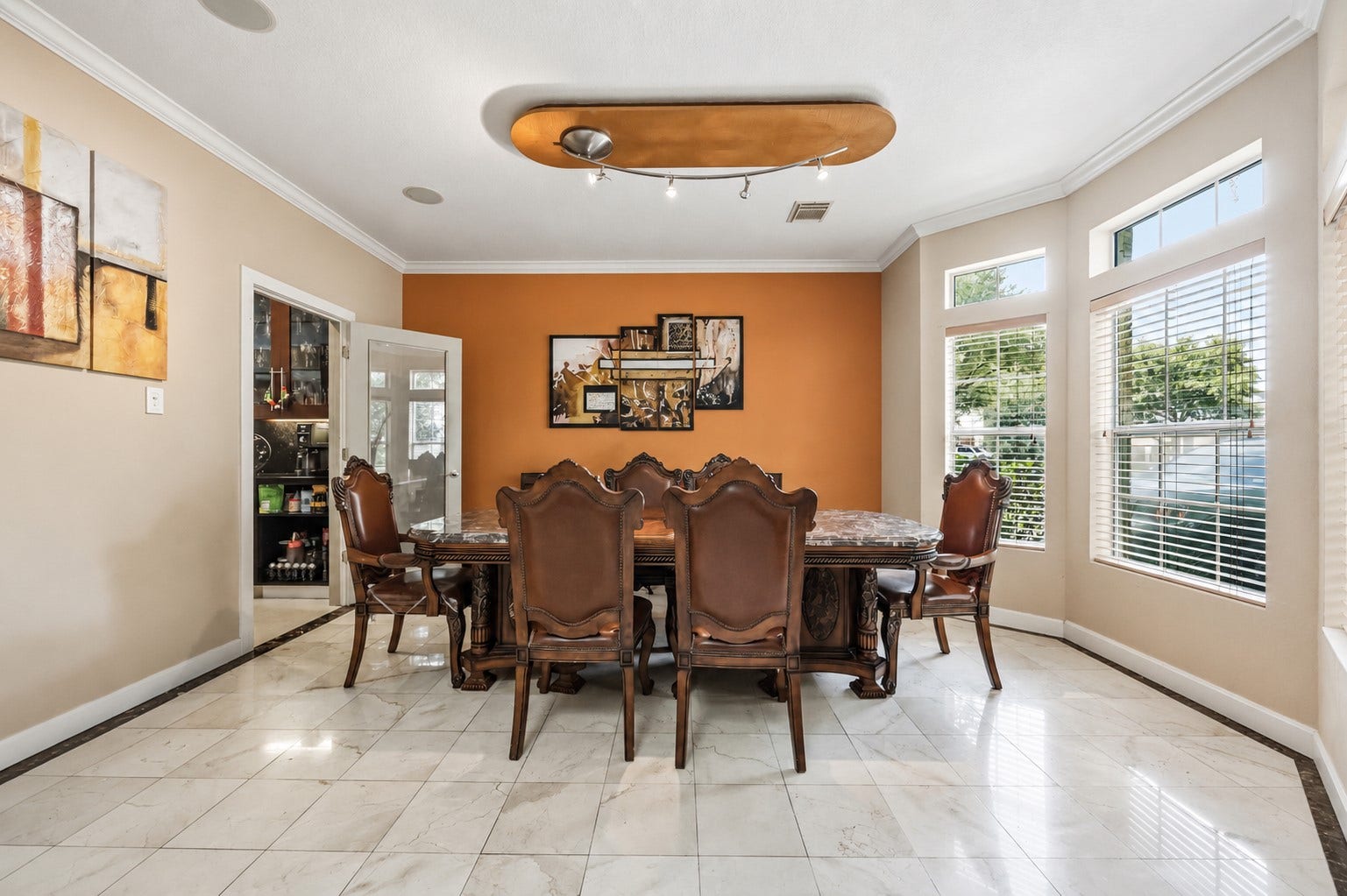 7610 Guinevere Drive, Sugar Land, TX 77479 The formal dining room offers a smooth plaster ceiling with a modern track lighting fixture, crown molding, and large side windows overlooking the yard.